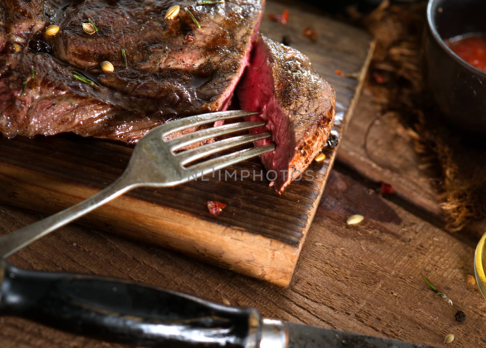 close up view on nice fresh steak on color background