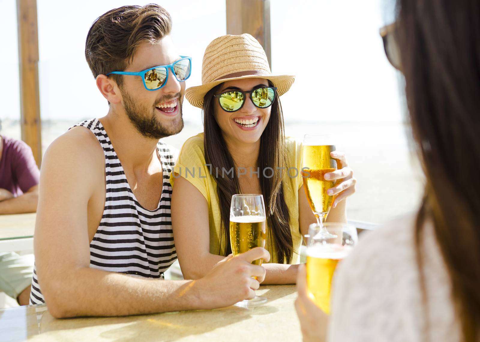 Friends drinking a cold beer by Iko