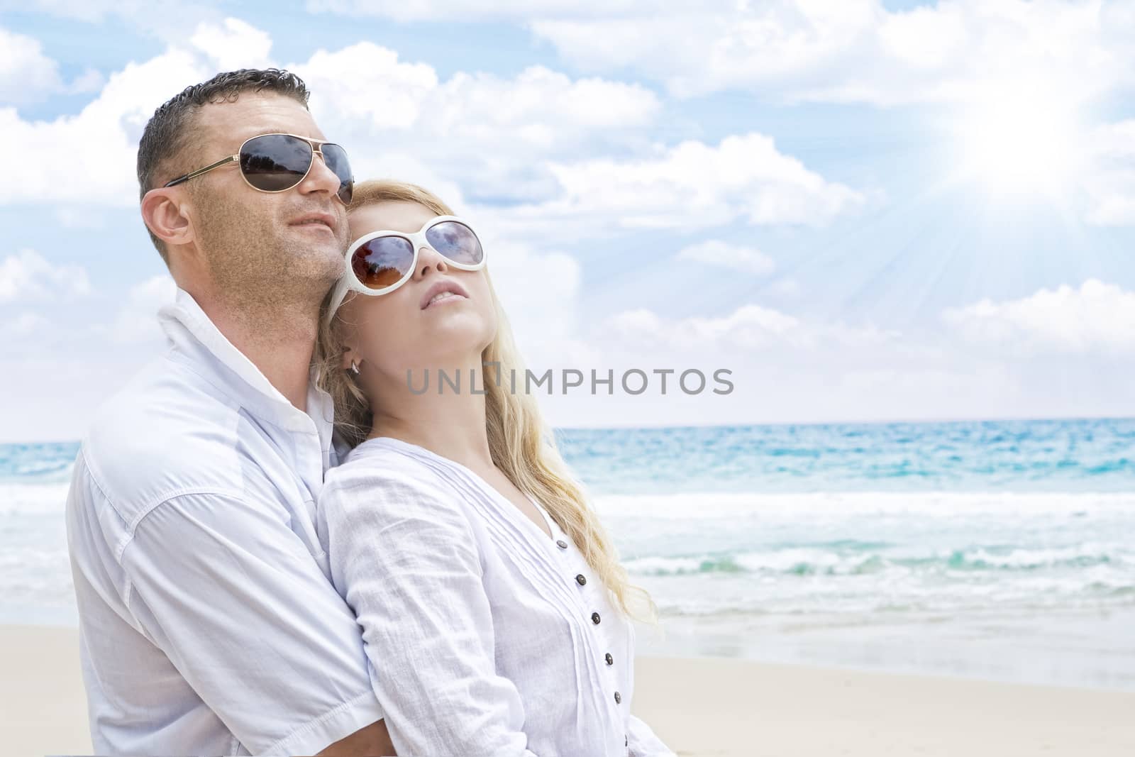 Portrait of young nice couple having good time on the beach