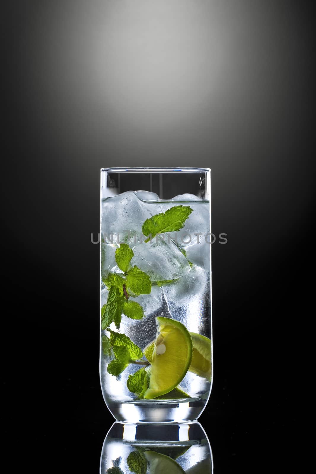 Close up view of mojito cocktail on black background