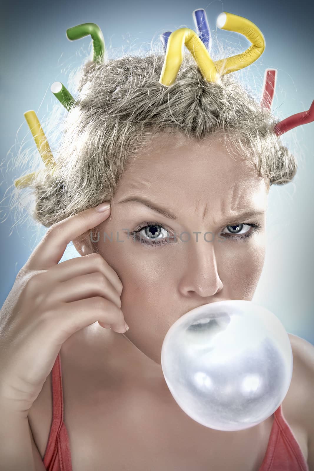 Close up portrait of young girl blowing big bubble