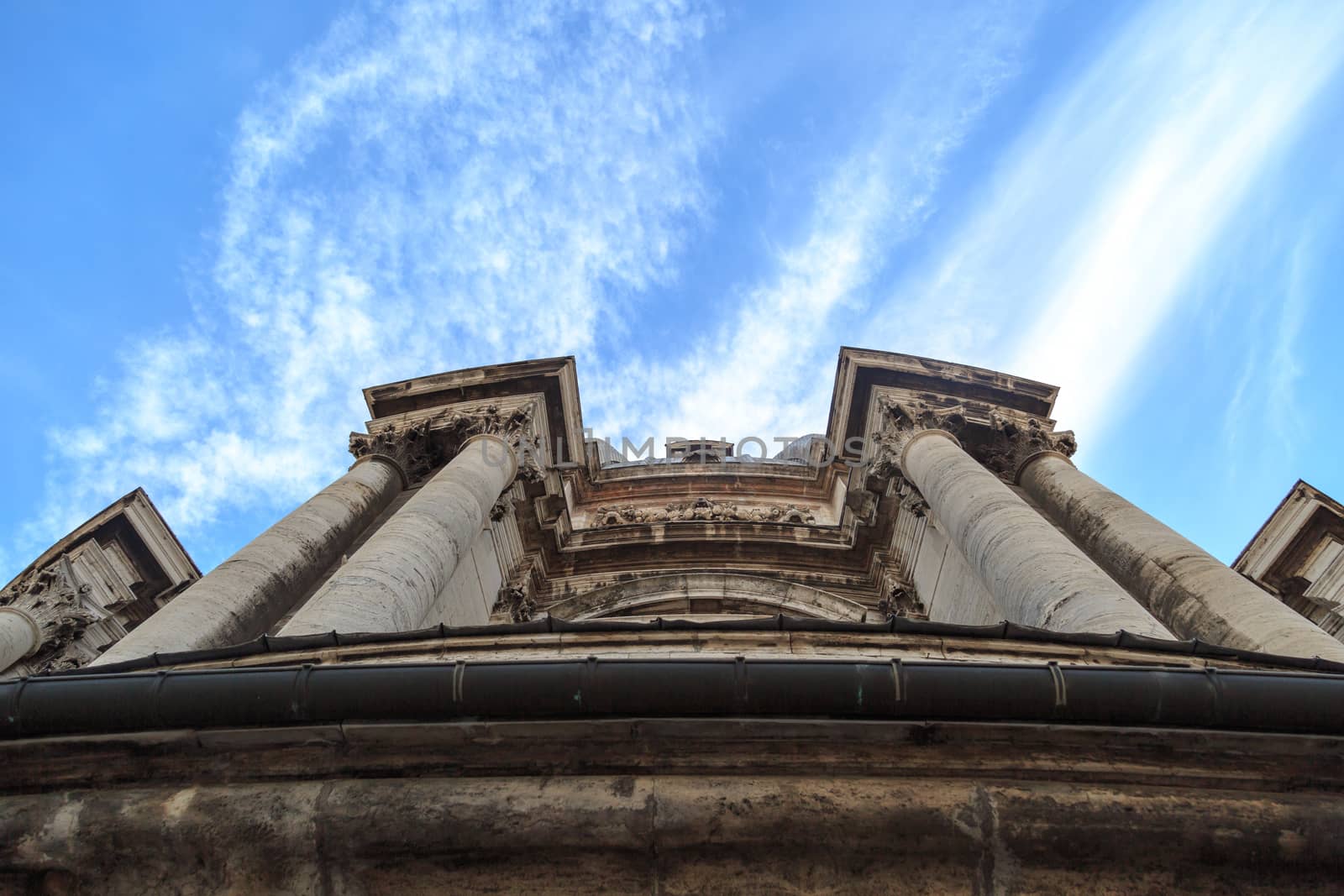 Close up detailed dome view of Saint Peter's Basilica in Vatican, on cloudy blue sky background.