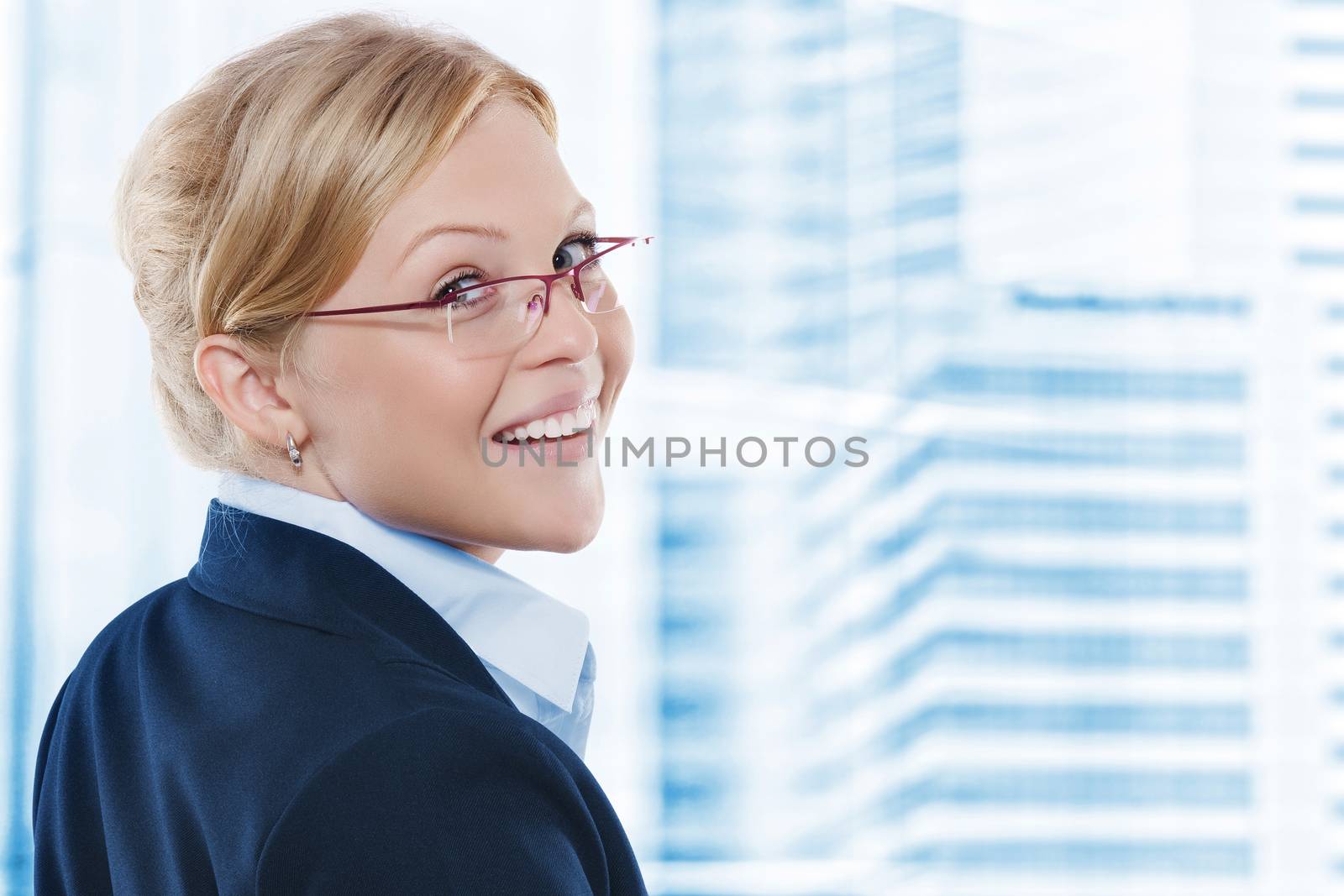 Portrait of young beautiful woman in office environment