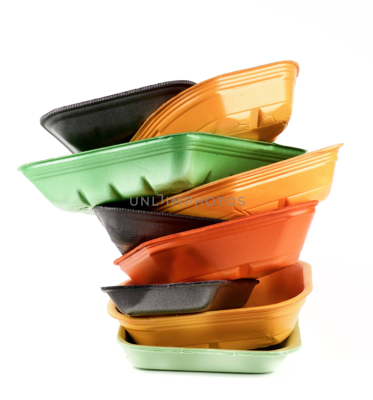 Arrangement of Black, Green and Orange Empty Recycled Trays isolated on White background