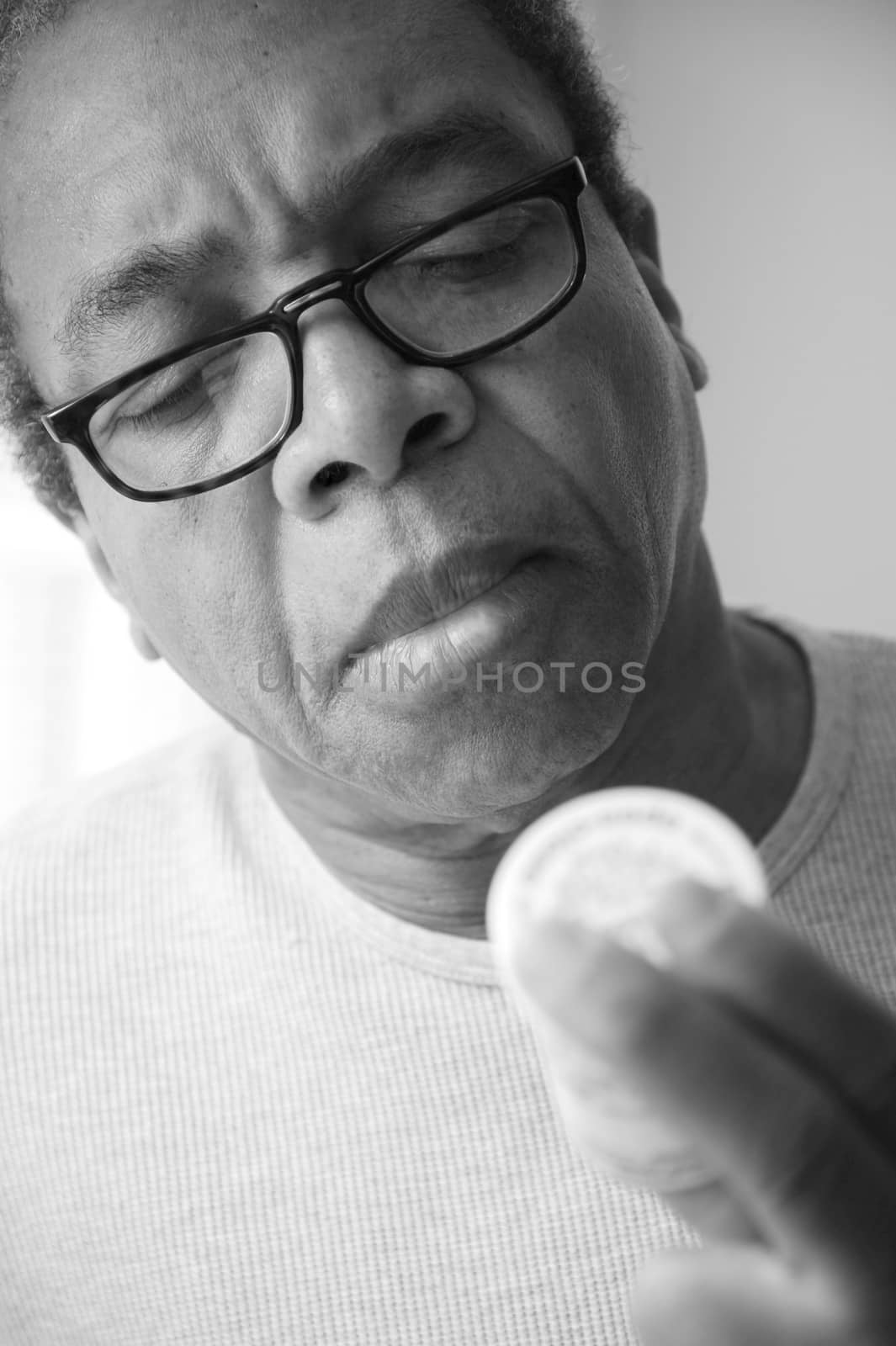 African american male taking his blood pressure medication at home.