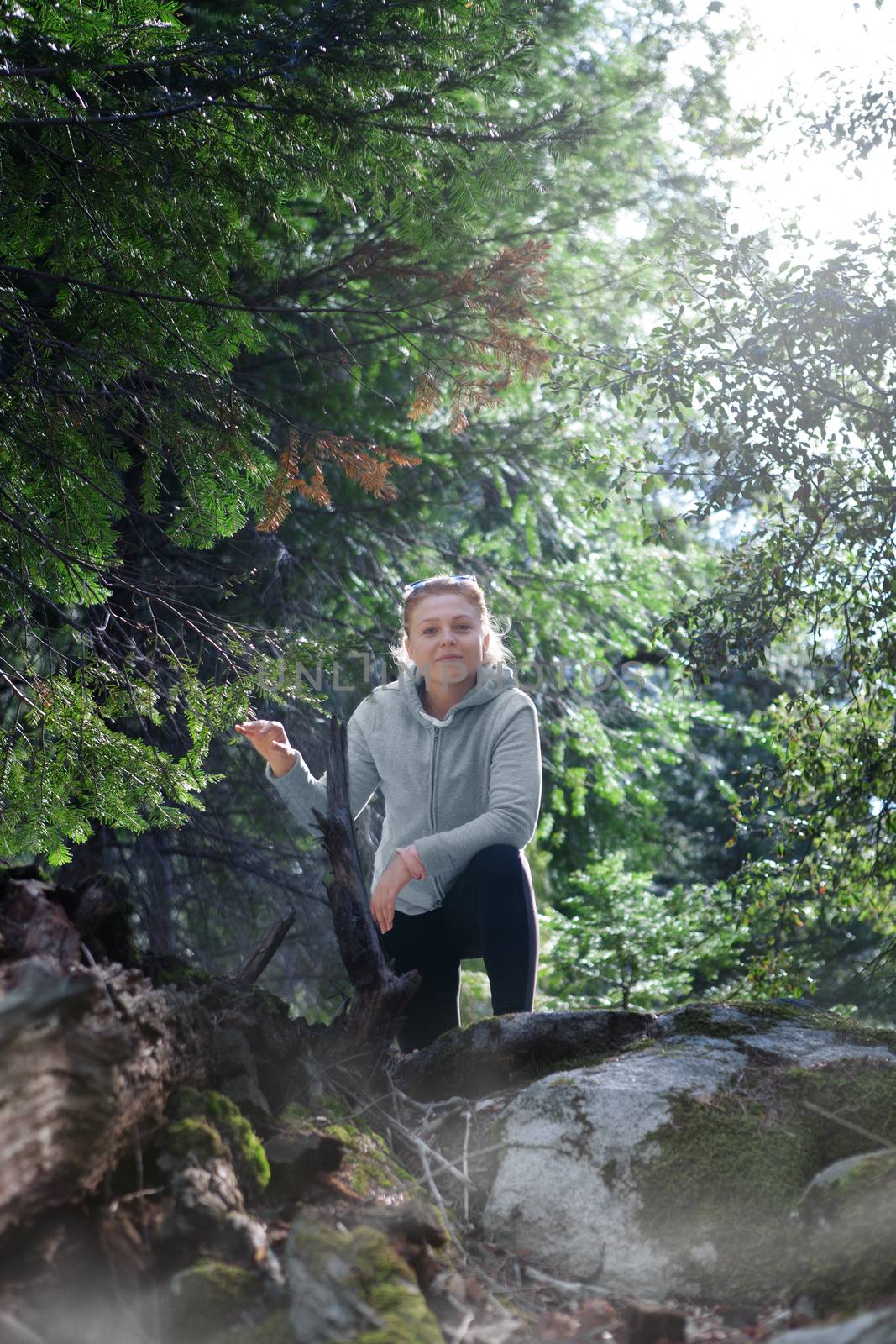 Portrait of nice young girl hanging out in summer forest