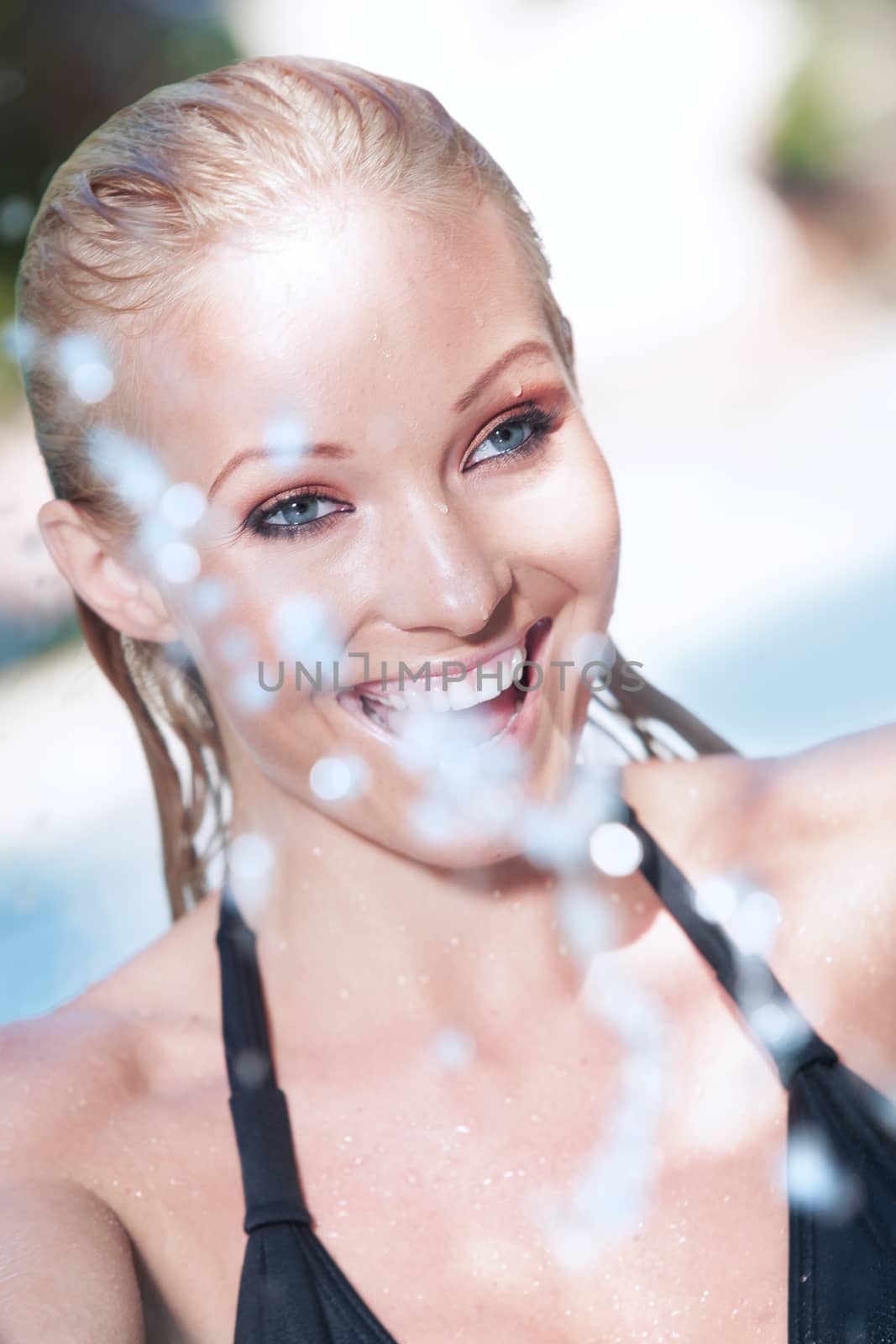 Portrait of young attractive woman having good time swimming pool