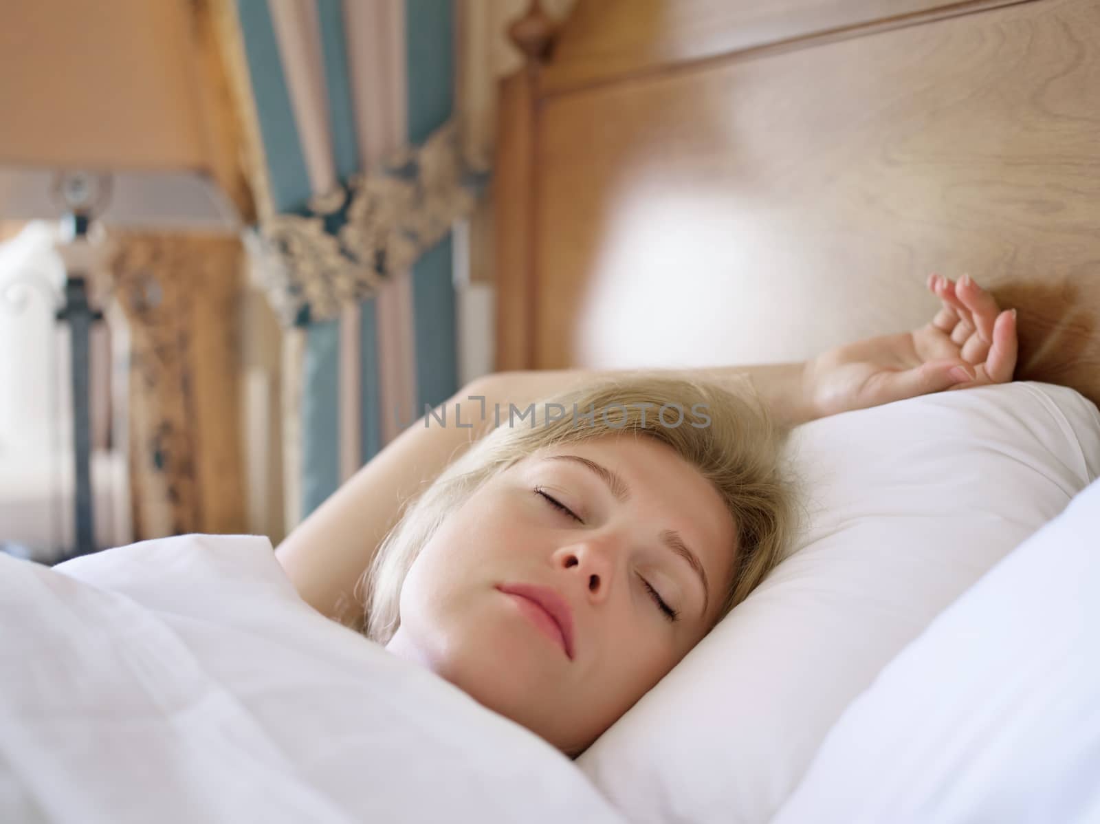 close up portrait of sleeping young woman on color back