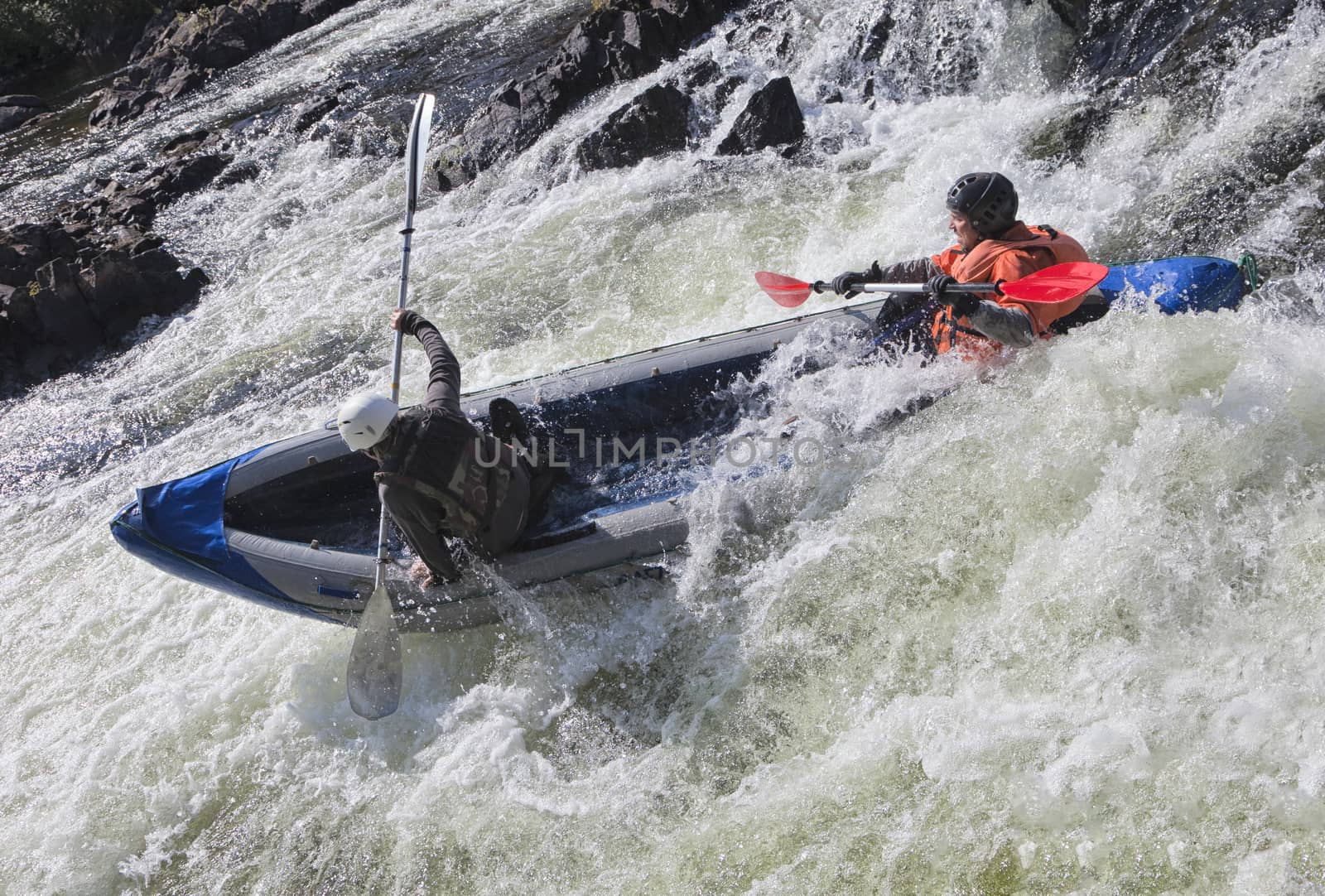 Kayakers in the  whitewater of a river Umba in Russia