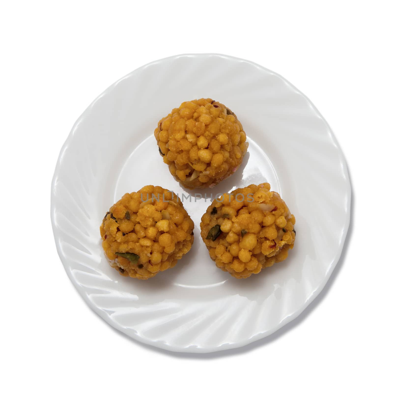 Indian sweets on a plate isolated over white