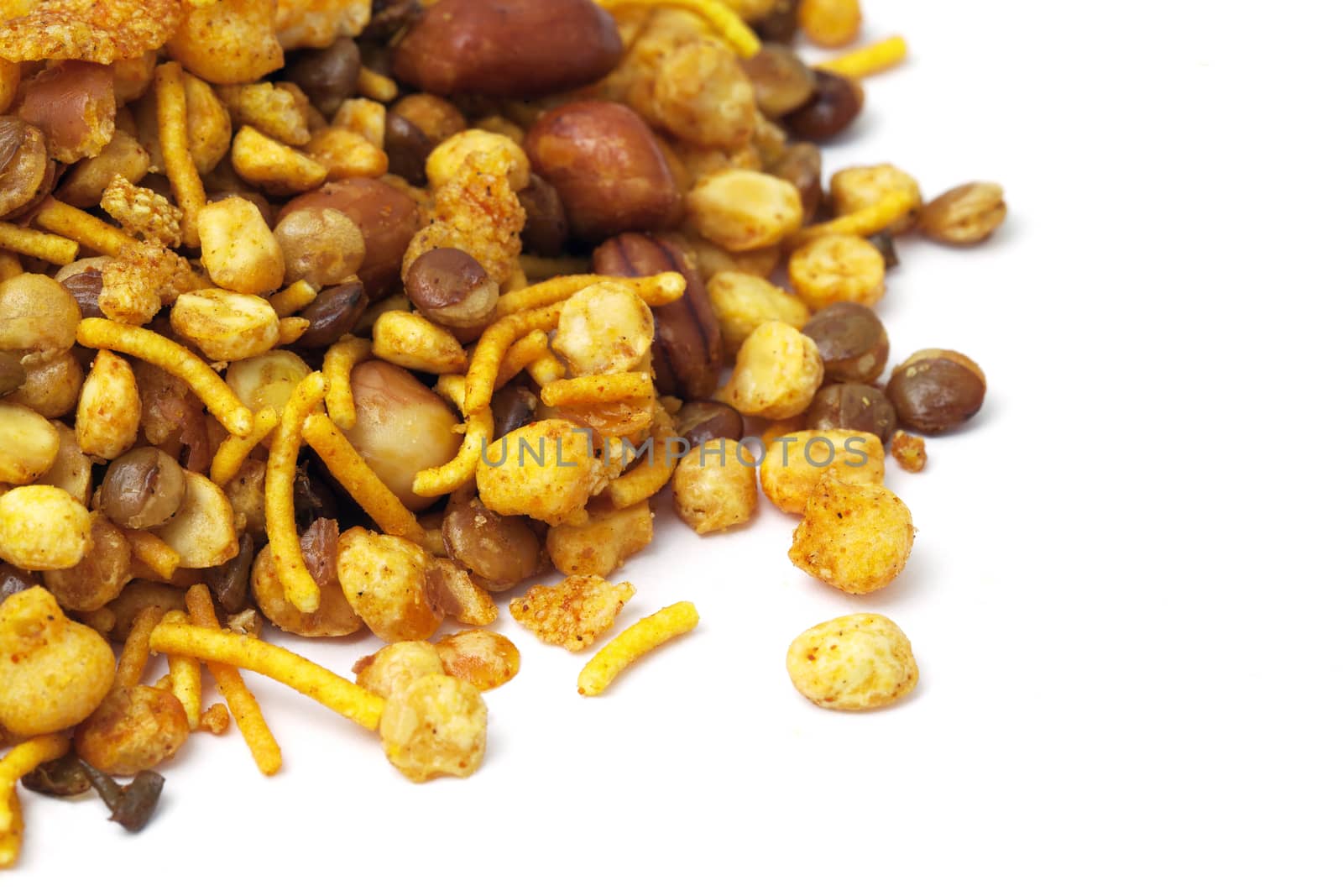 Pile of dry roasted Indian snack mix, isolated over white