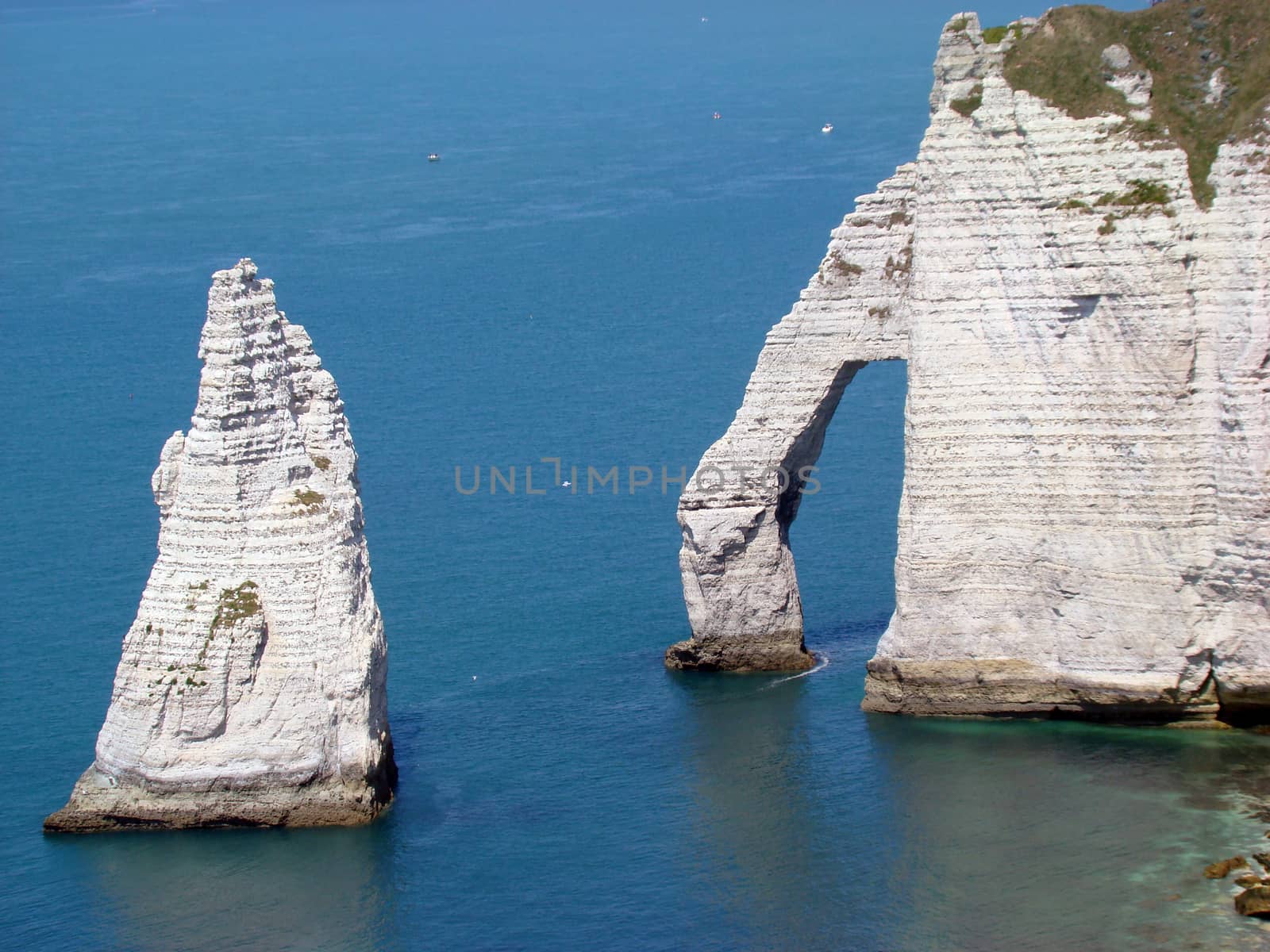 Etretat Aval Cliff, natural Rocks and Arch Landmark and blue Ocean in Normandy, France