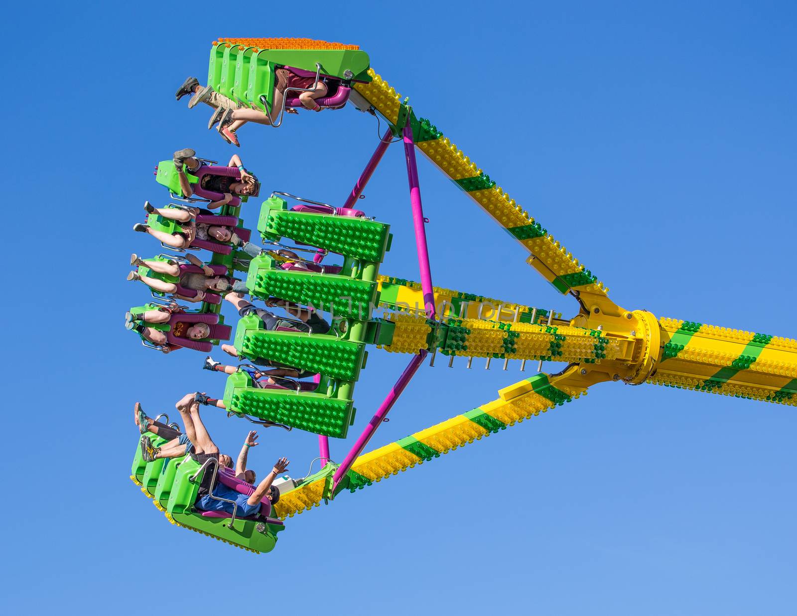 Anderson, California, USA- June 17, 2015: Fair goers enjoy the carnival ride Freak Out at the Shasta County FairThe Freak Out is a pendulum shaped ride that is very popular.