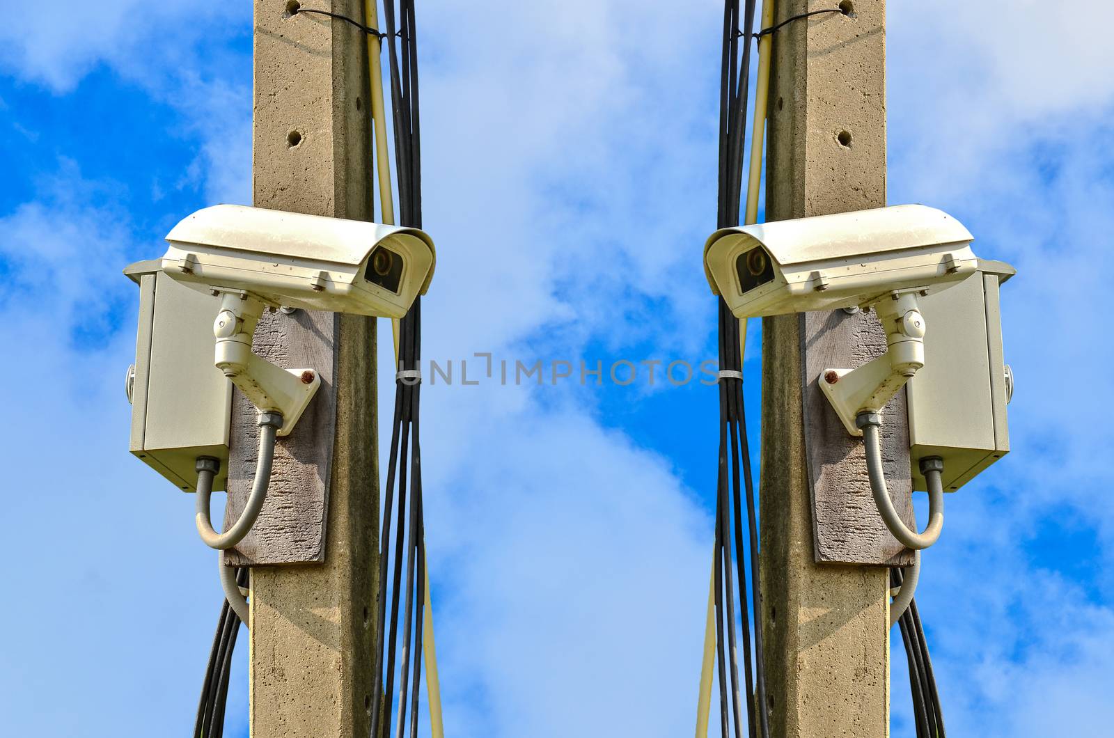 Two closed circuit camera on blue sky background