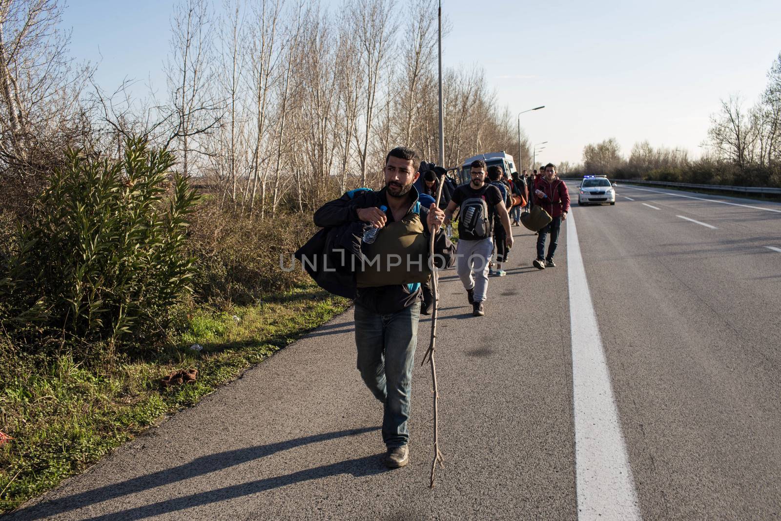 GREECE, Diavata: Migrants walk from Diavata, near Thessaloniki, Greece toward Idomeni border's crossing, on February 25, 2015. Hundreds left Diavata camp, a refugee center near Thessaloniki to reach the Greek-Macedonian border. 