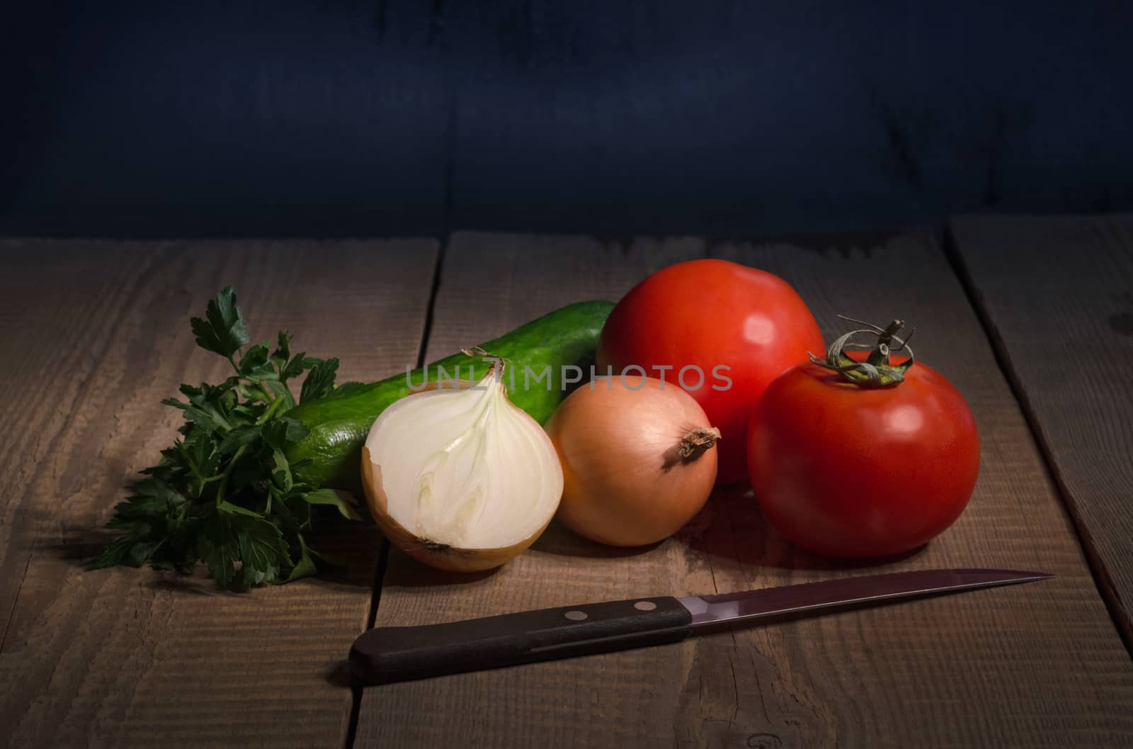 Vegetables are on the old wooden table by Gaina