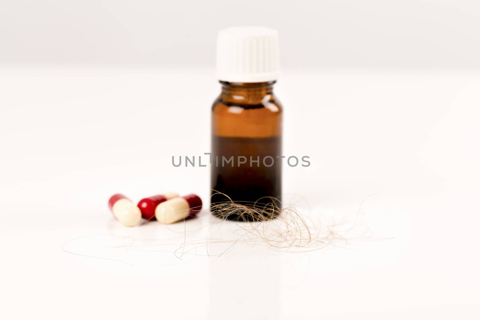 Close-up of  lost brown red hair, treatment homeopathy essential oils plant pills