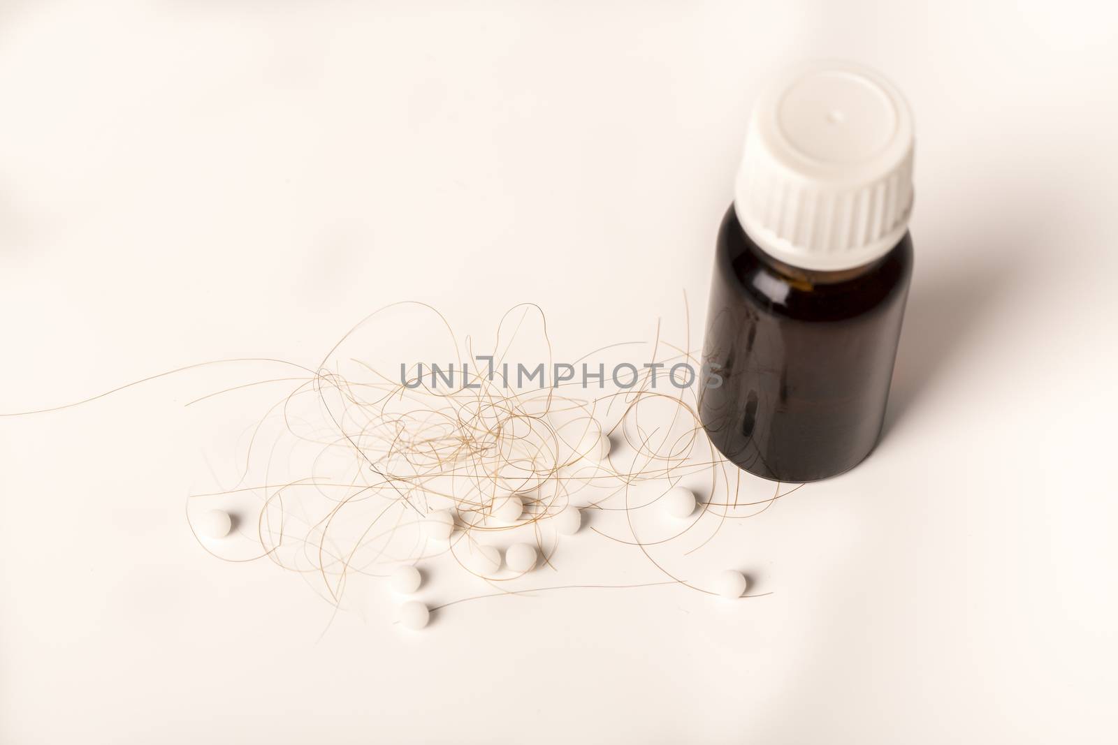 Close-up of  lost brown red hair, treatment homeopathy essential oils plant pills