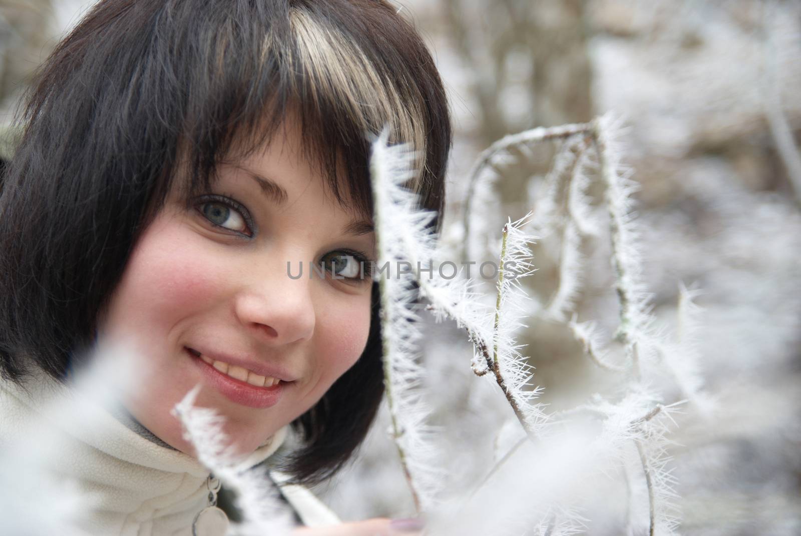 Pretty winter girl in the snow forest