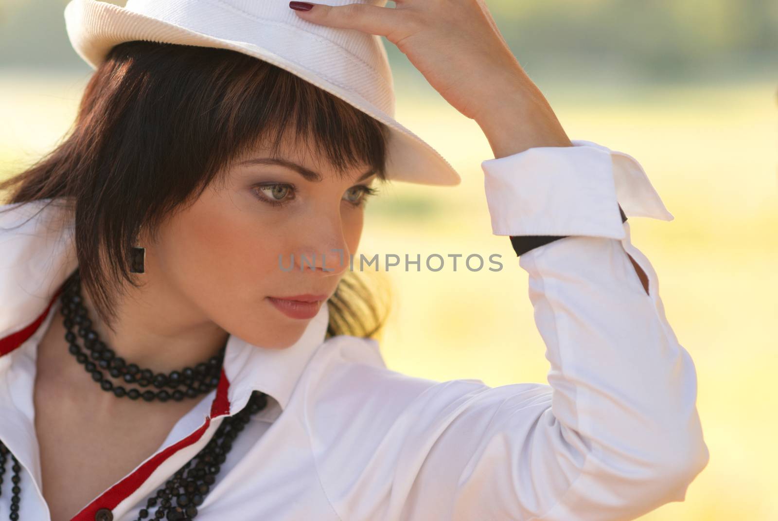 Beautiful girl in the white hat- soft background portrait