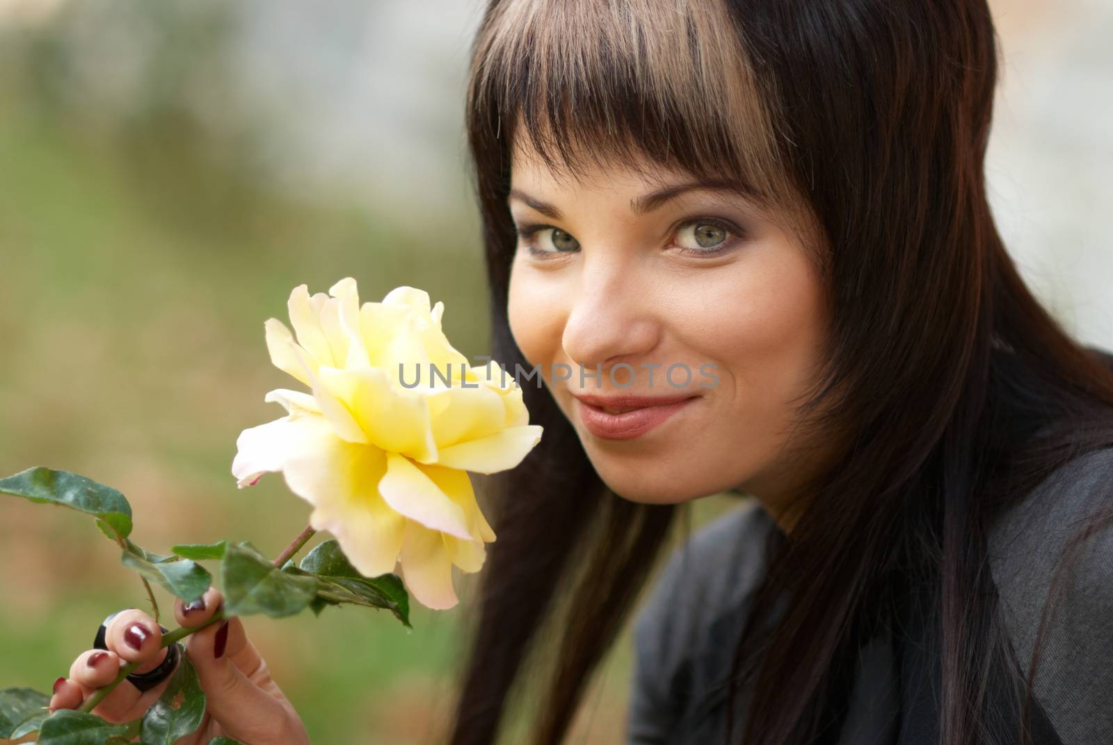 Beautiful girl with yellow rose, soft background