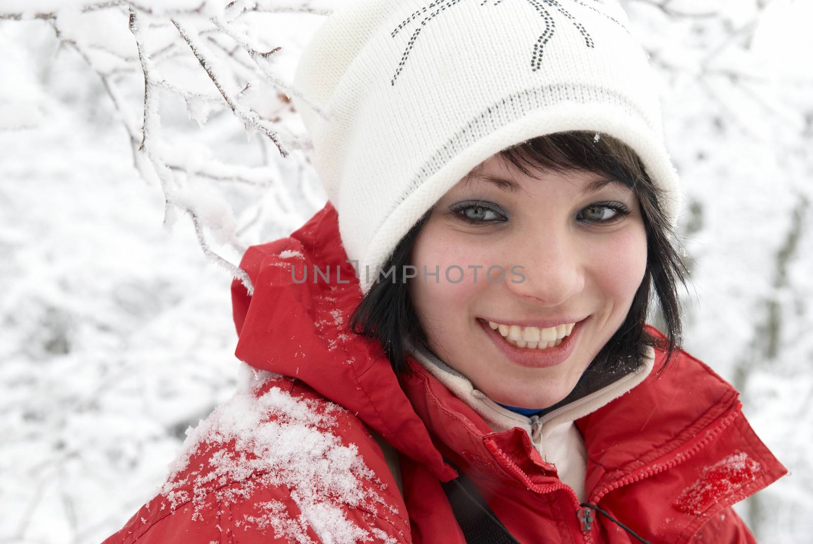 Pretty winter girl in the snow forest