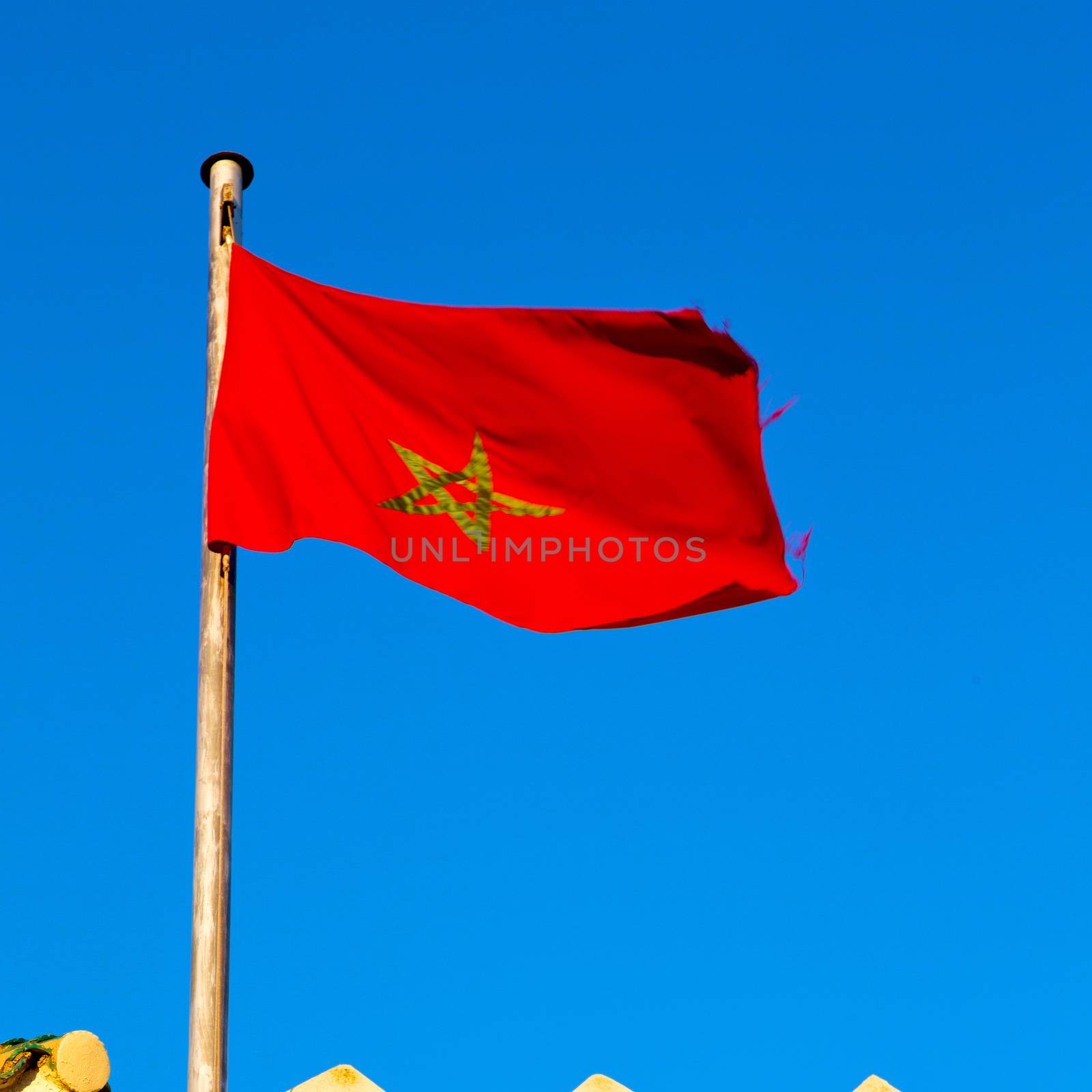 waving flag in the blue sky tunisia  colour and wave battlements