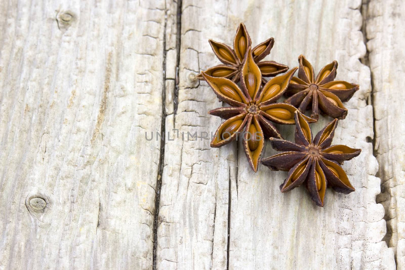 star anise on wooden background by miradrozdowski