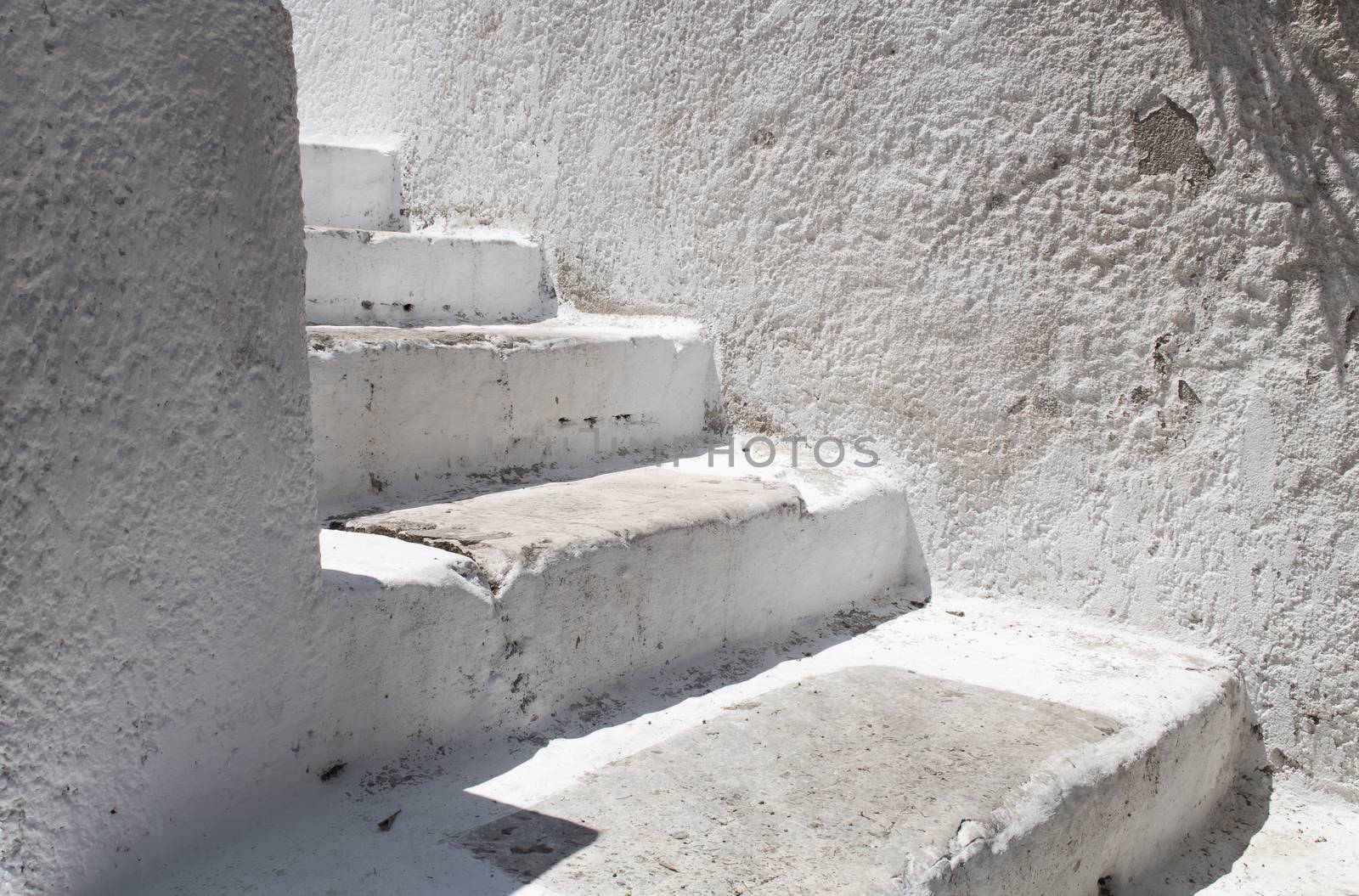 White stairs to the house between two walls with a white facade. Athens, Greece.