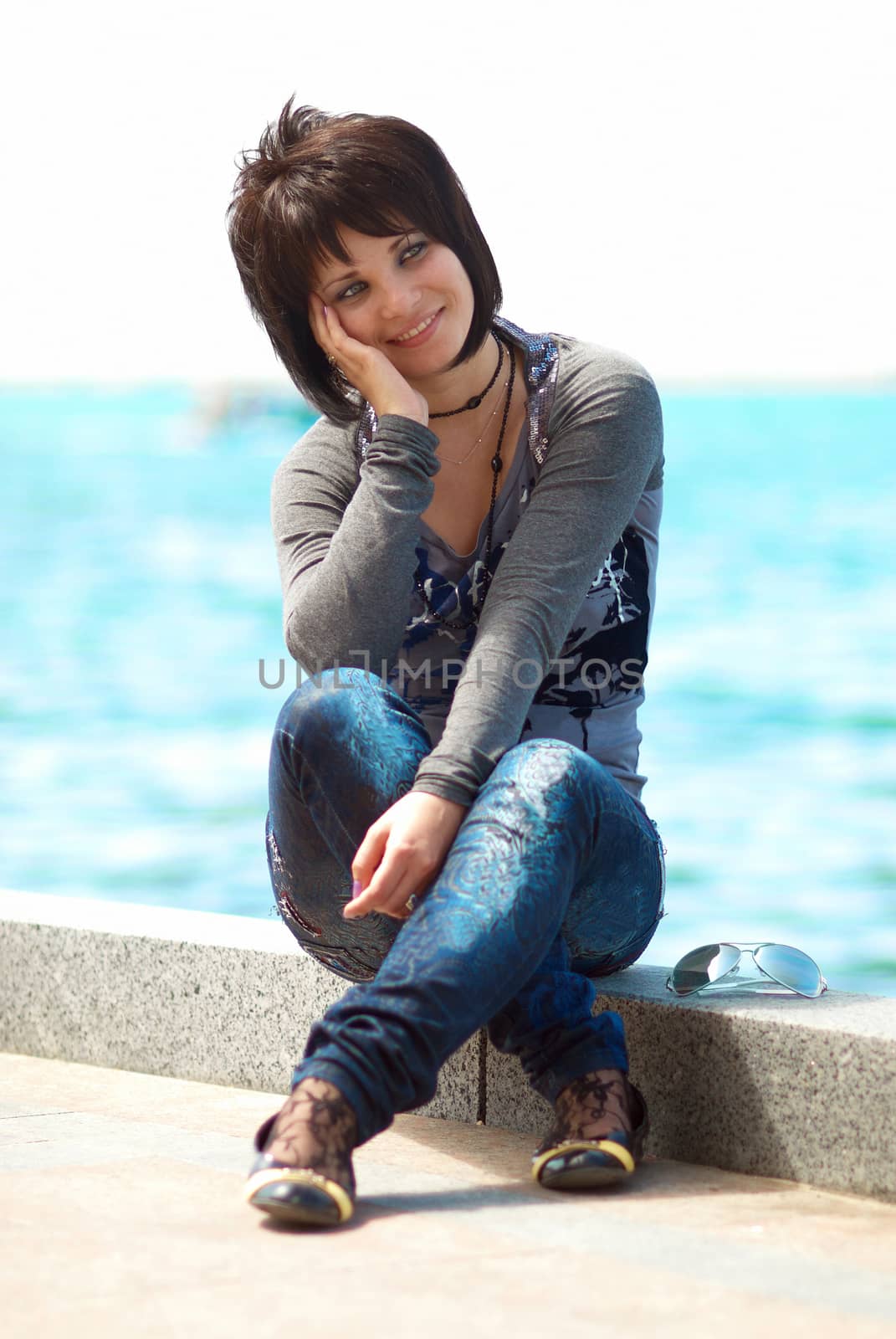 Pretty brunette young girl near the sea