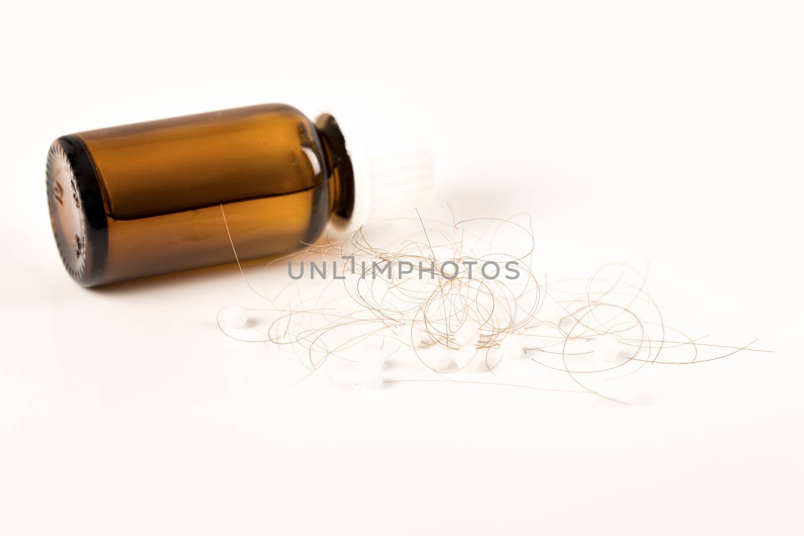 Close-up of  lost brown red hair, treatment homeopathy essential oils plant pills