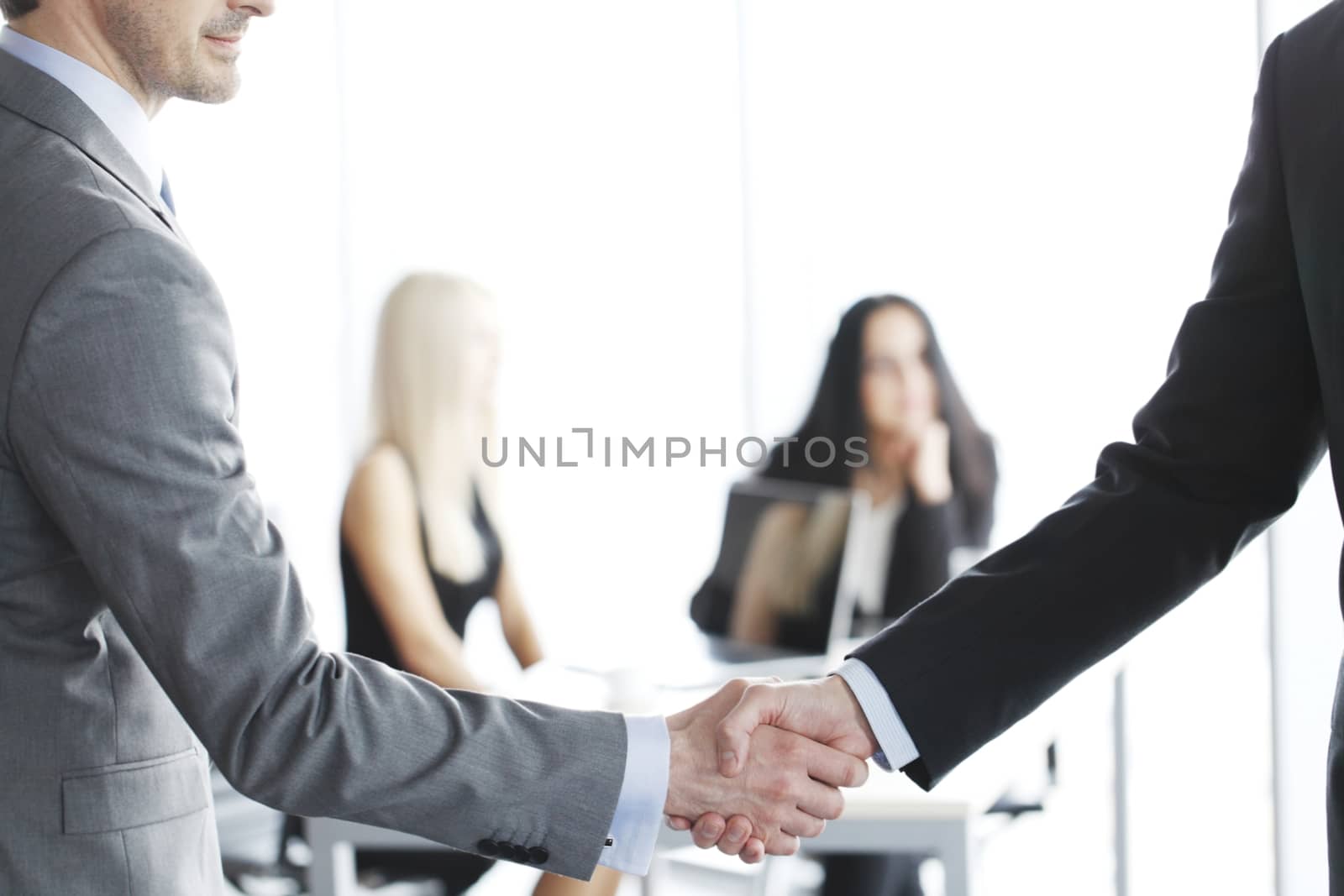 Close-up of handshake of businessmen on meeting in office