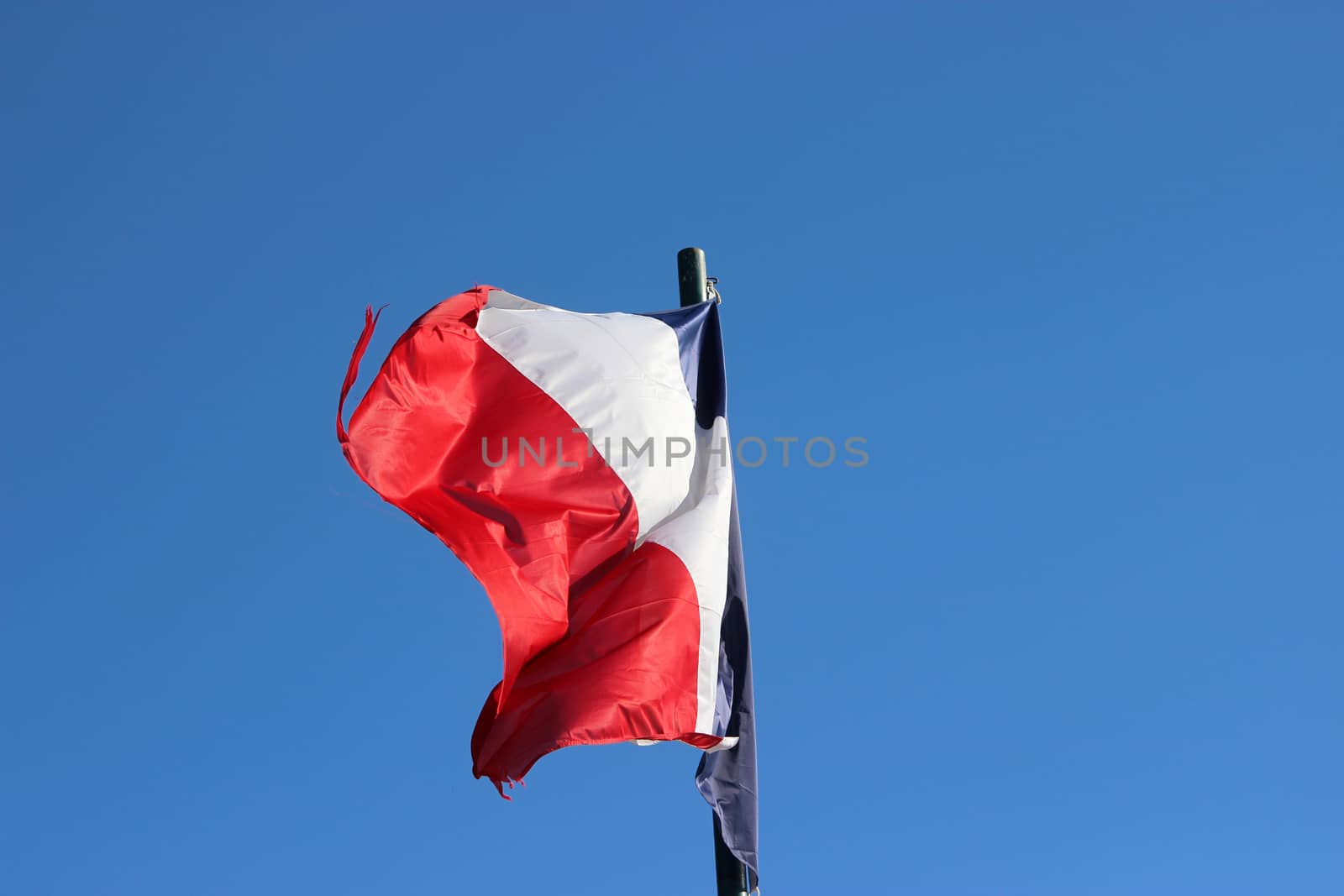 Flag of France waving against Blue Sky. Nice, France