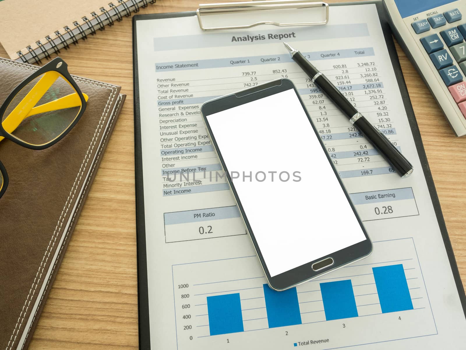 smart phone on work desk with notebook ,report, pen.