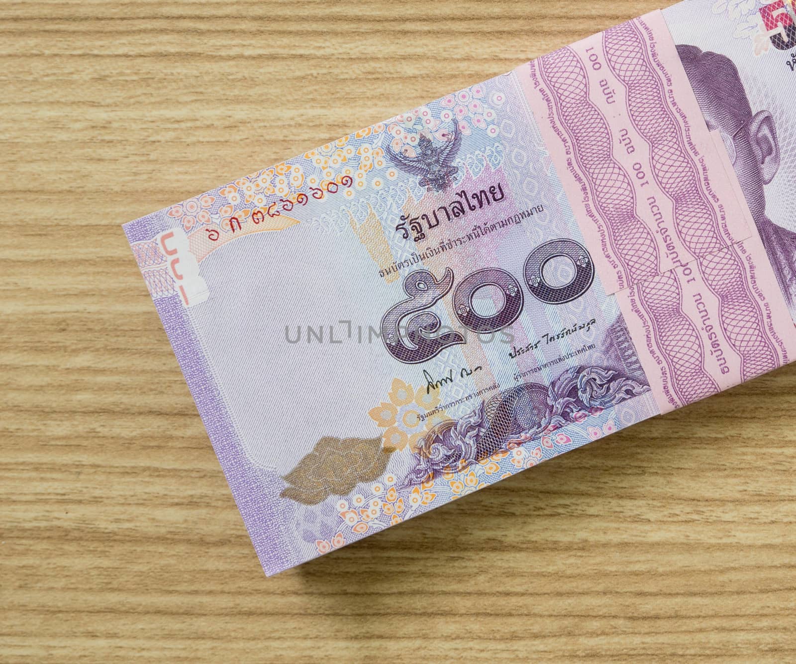 five hundred  thai banknotes put on table .  money concept