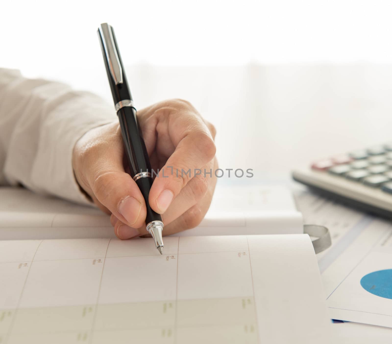 businessman record data on  to schedule a meeting or event
