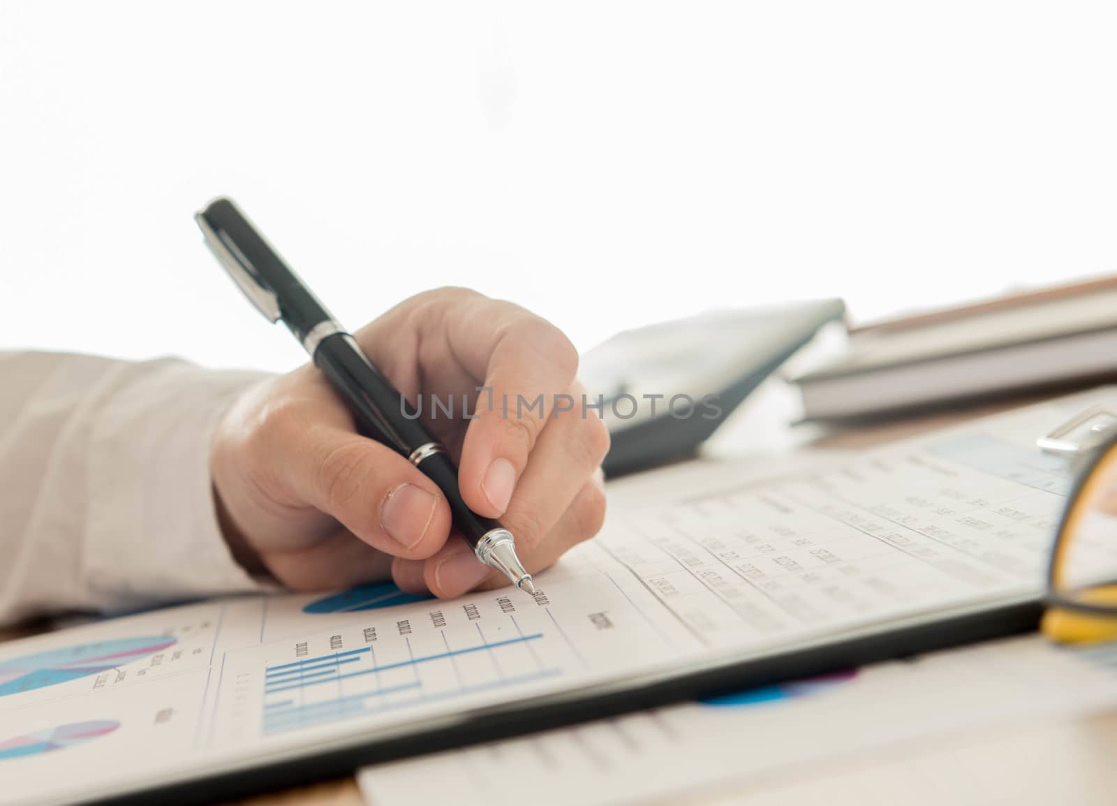 Businessmen are analyzing data from graph reports.