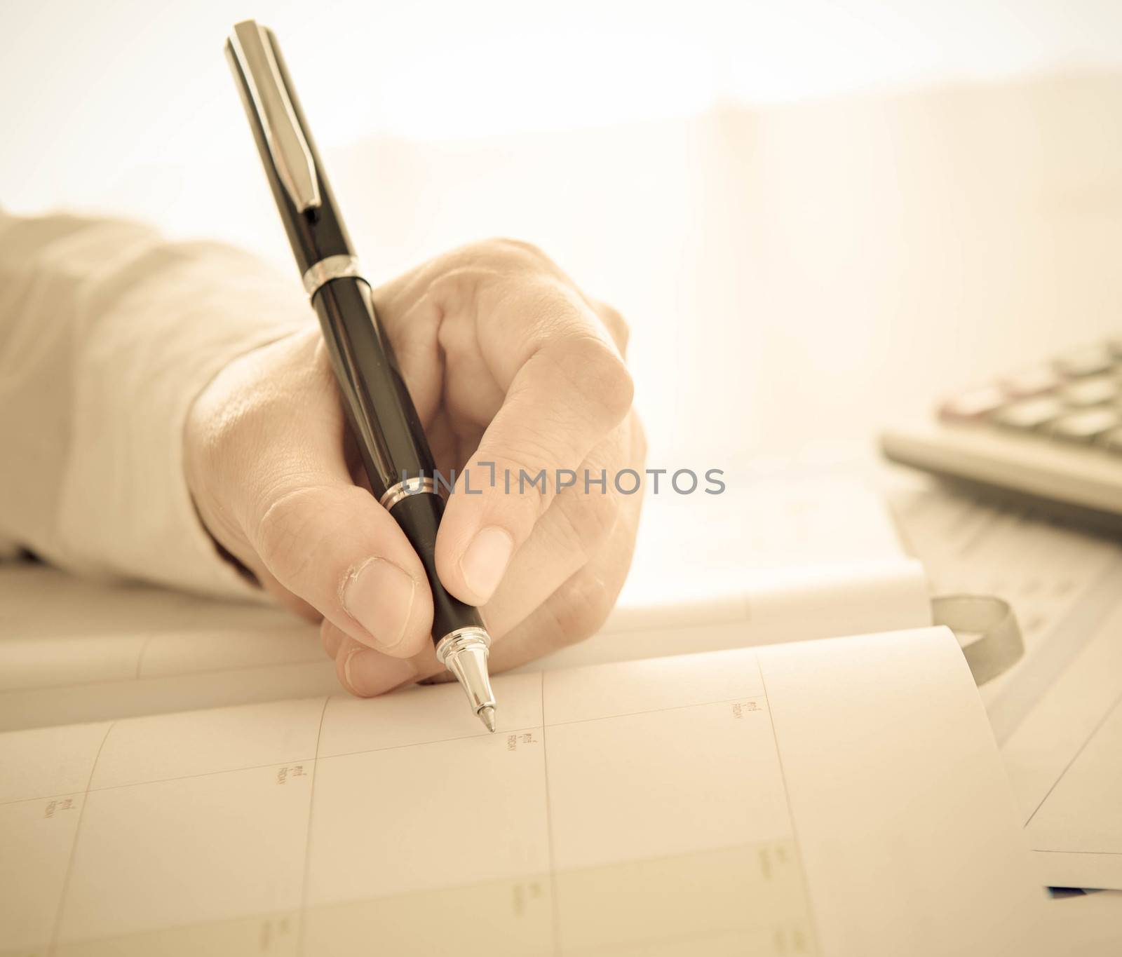 businessman record data on  to schedule a meeting or event