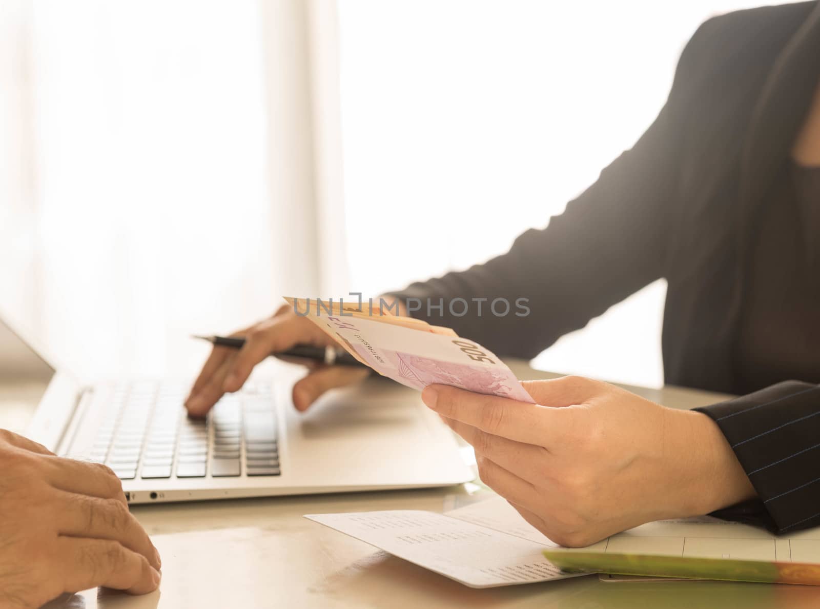 Bank employees are receiving deposits or payments from customers