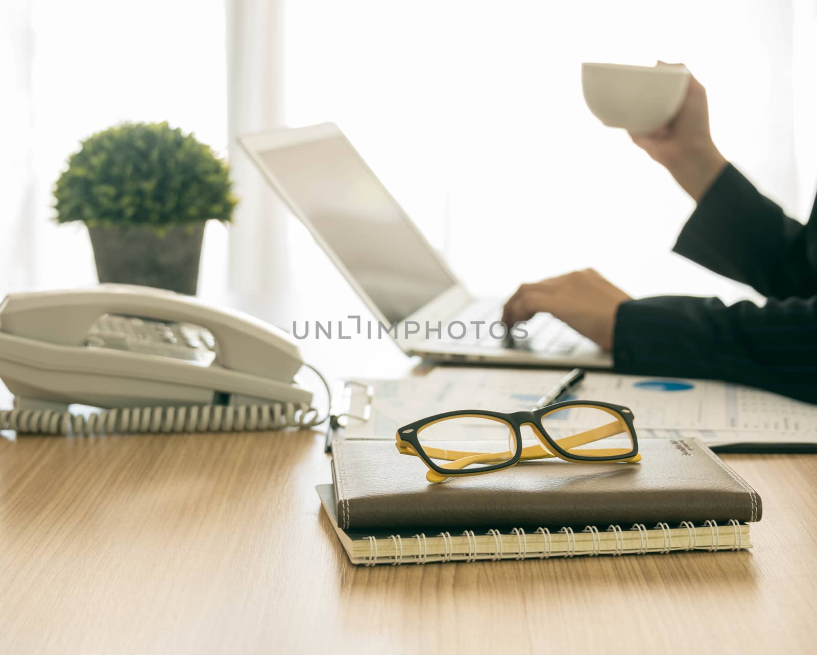 glasses on the desk of a working woman.