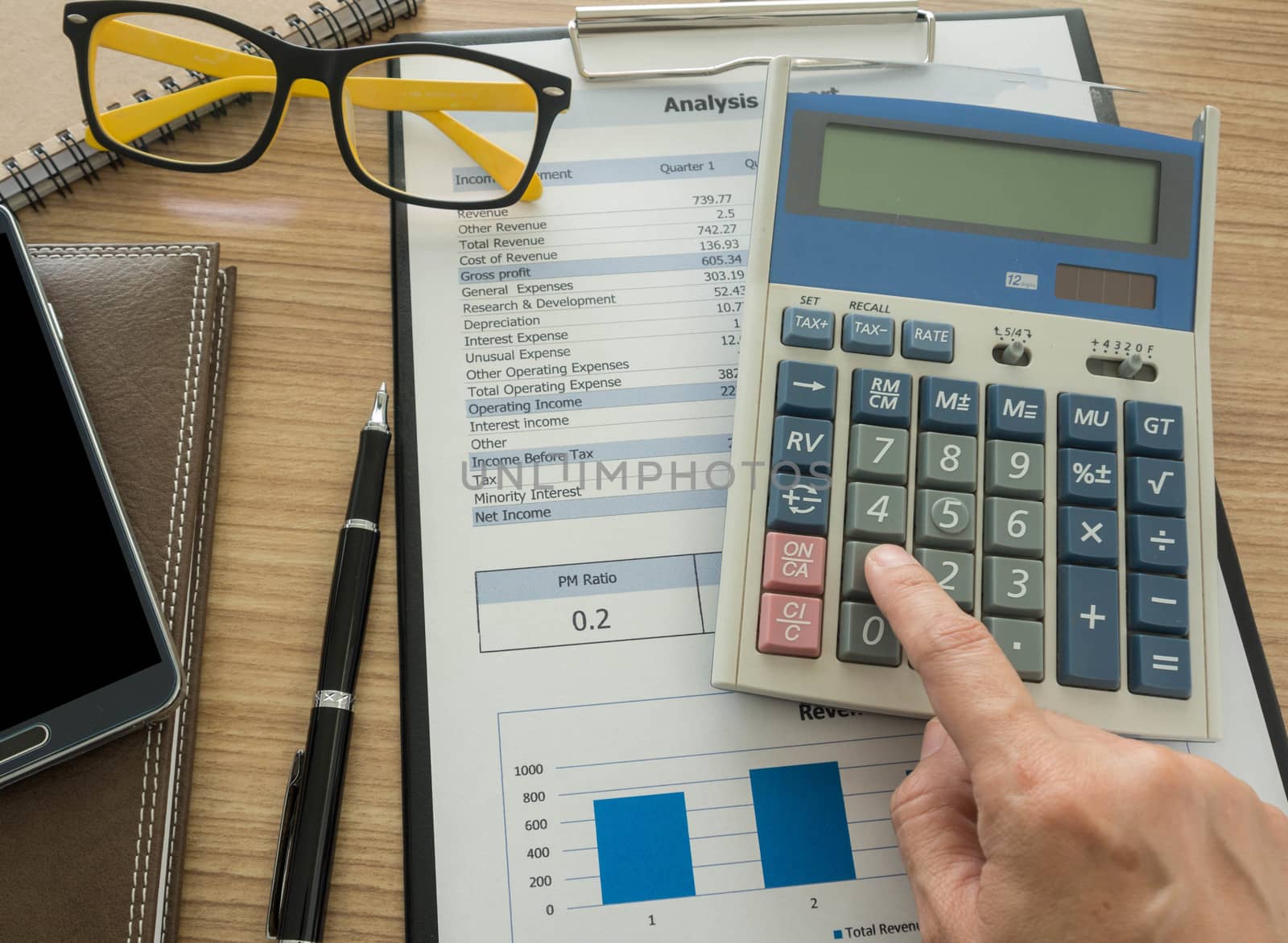 Accountant calculating numbers using a calculator.