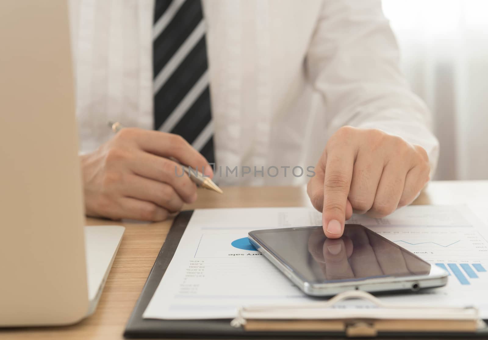 close up businessman's fingers touching the screen smartphones.