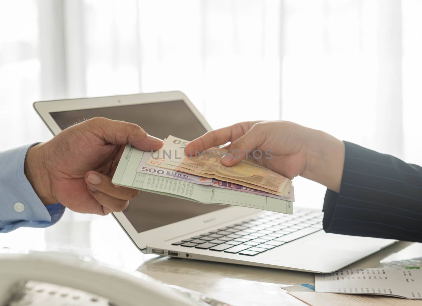Businessmen are loan payment to the bank employees.