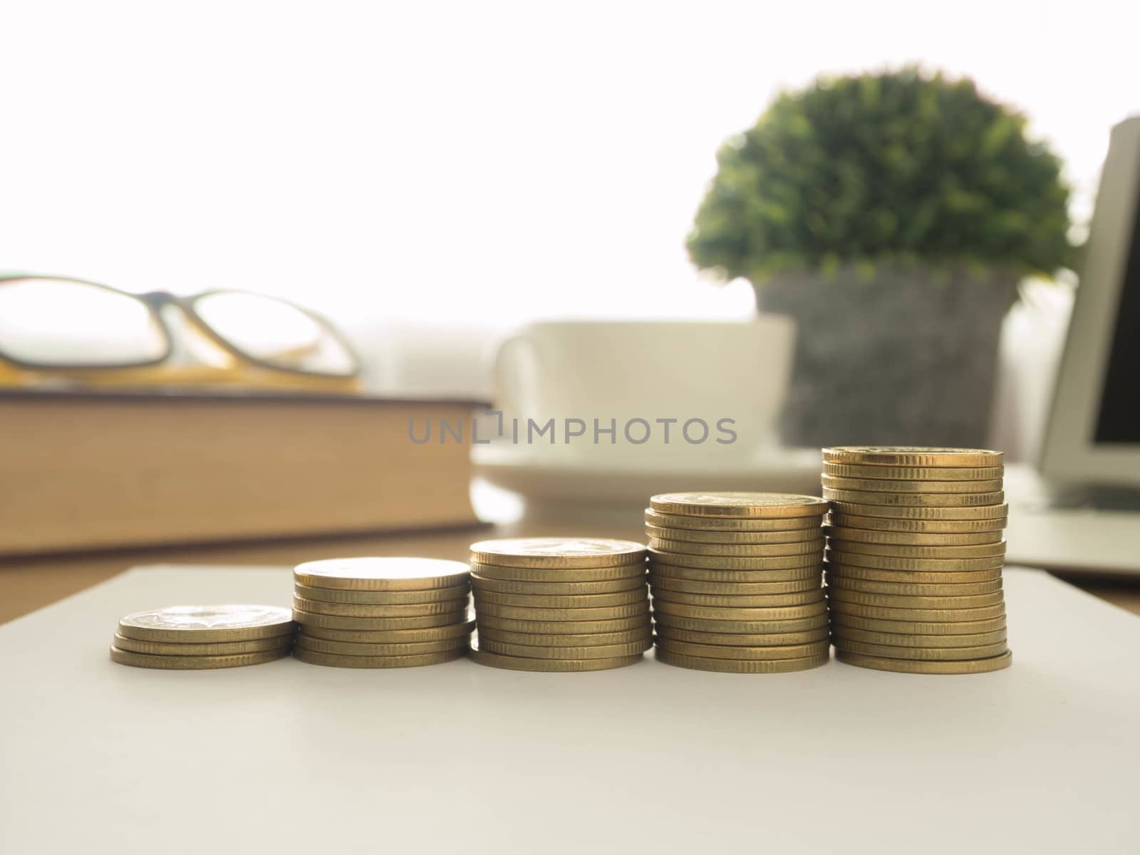 golden coins on office background. finance, business,develop concept
