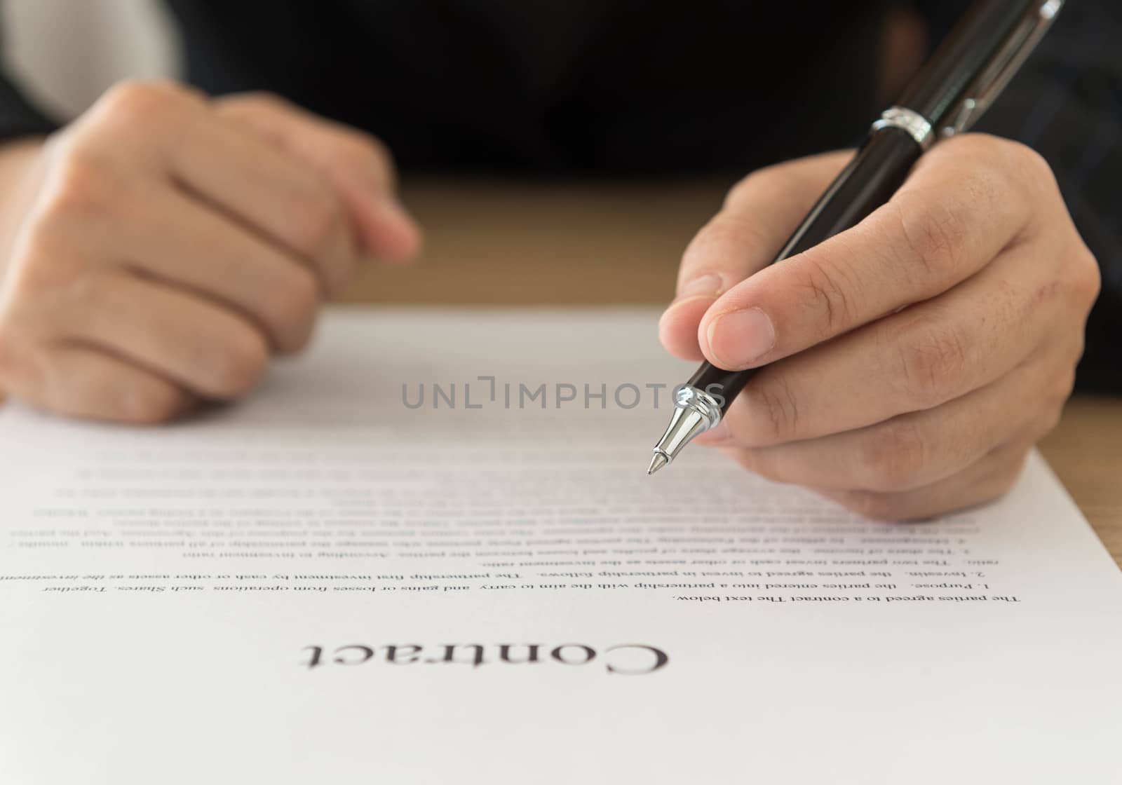 Close up Hand of businessman signing on formal paper