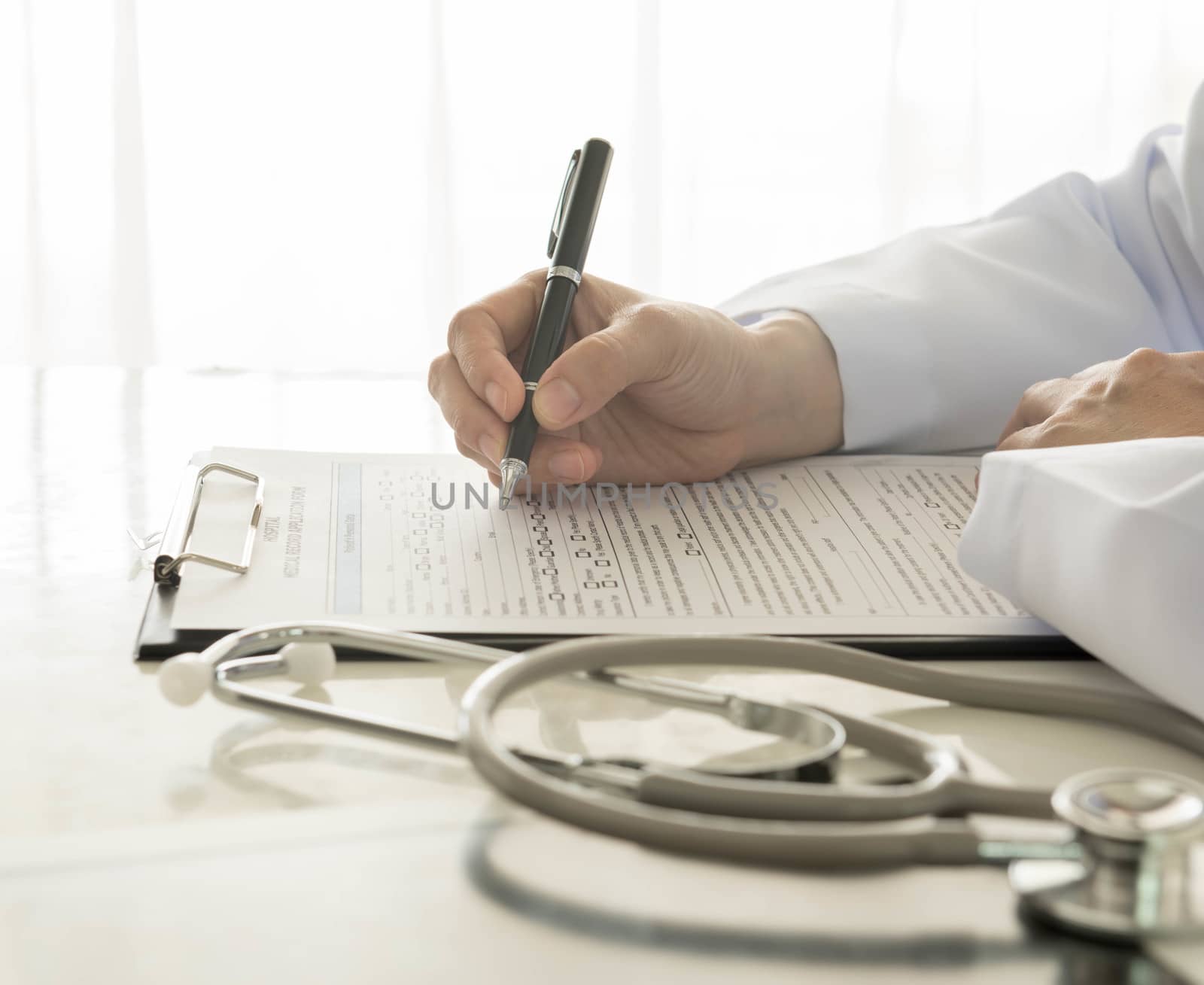 close-up of doctor taking notes on hospital