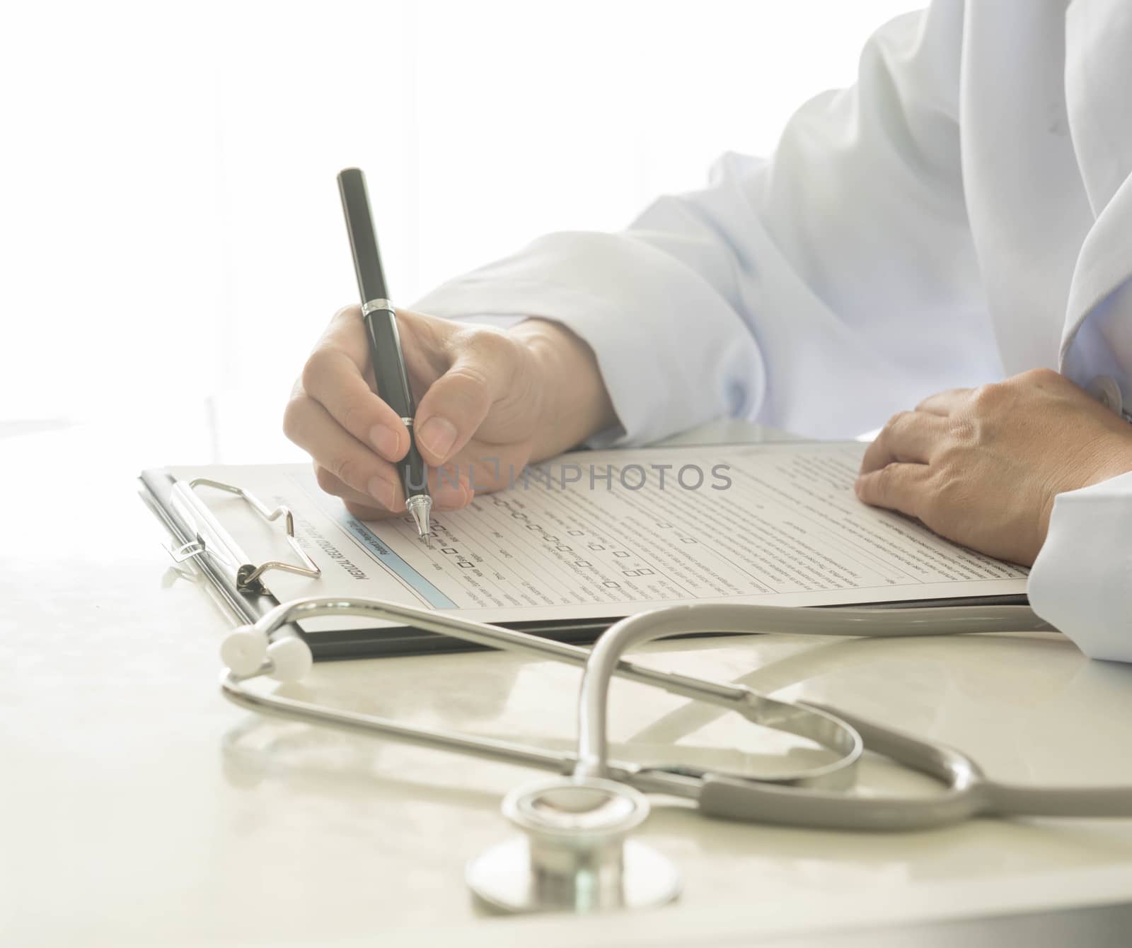 close-up of doctor taking notes on hospital