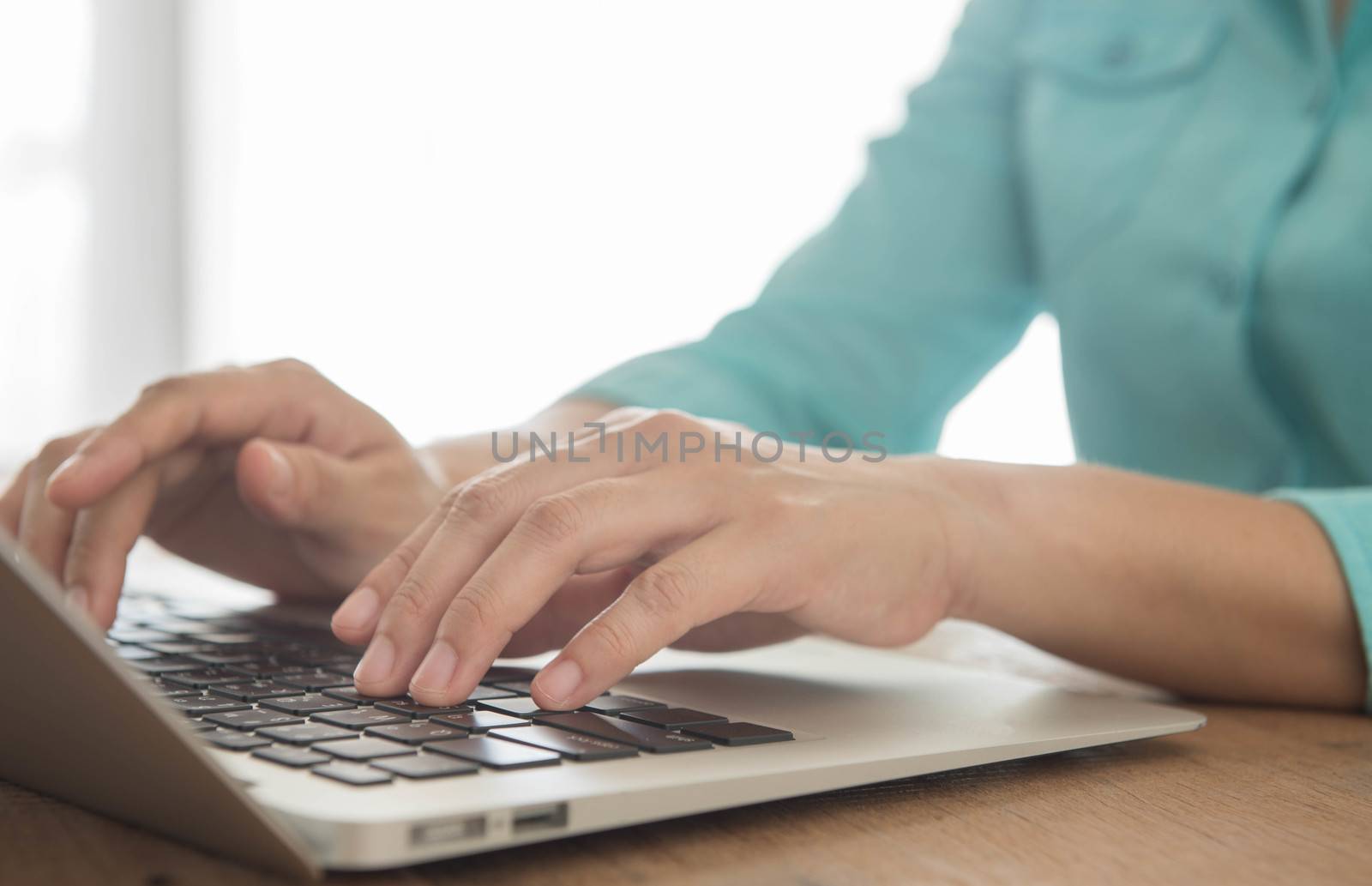 closeup a hands typing on laptop keyboard.