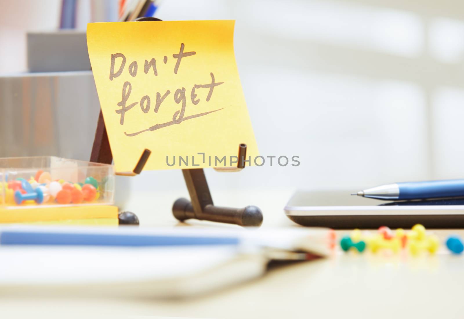 Do not forget text on adhesive note at office