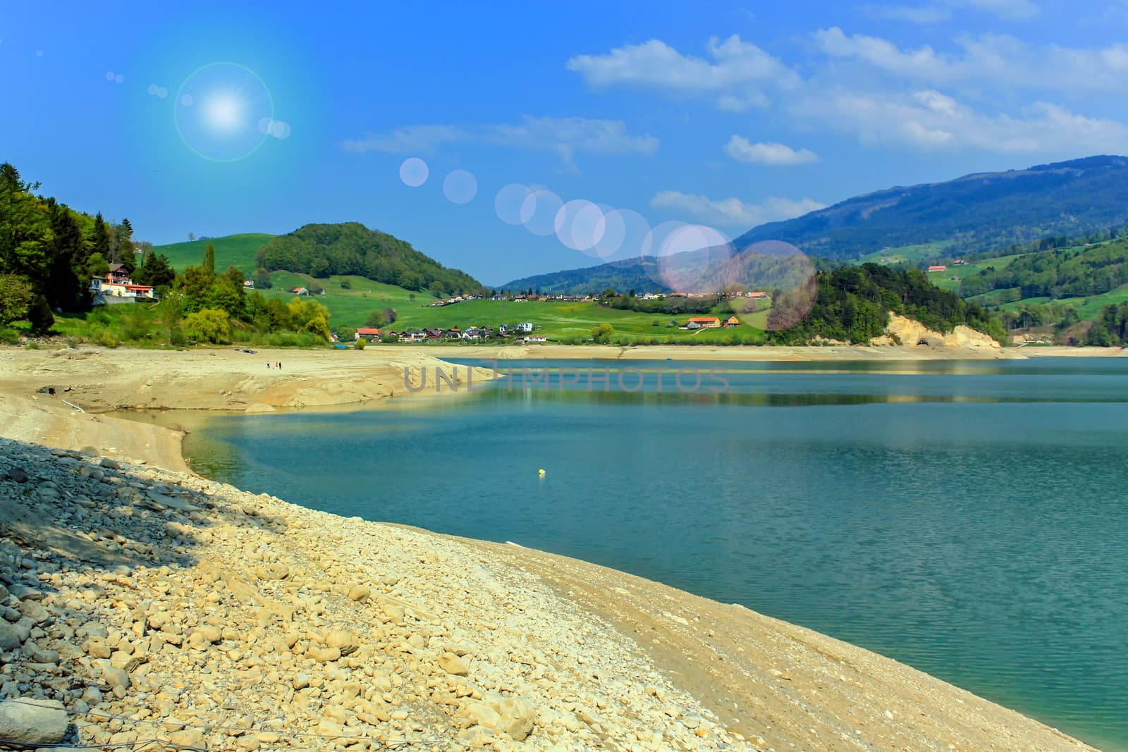 Dry Gruyeres lake in summer with sunrays, Fribourg canton, Switzerland